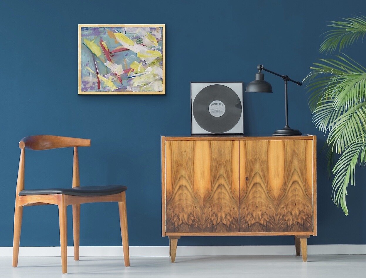 gestural abstract painting with bright yellow white red palette and brush strokes in room