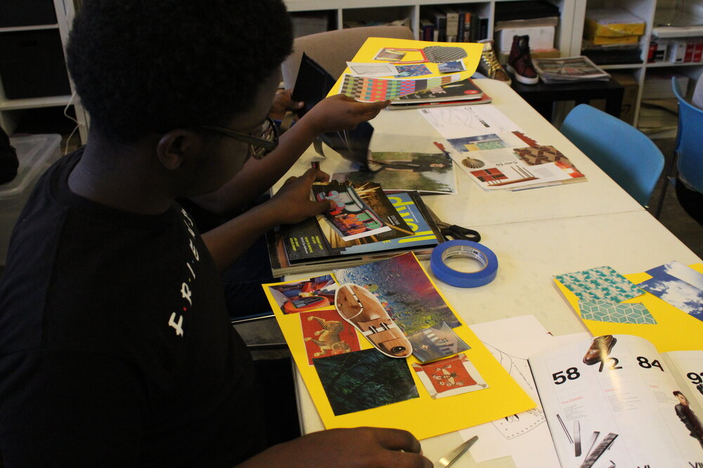  Student creating a colorful collage with cut paper. Credit: Mae Morris 