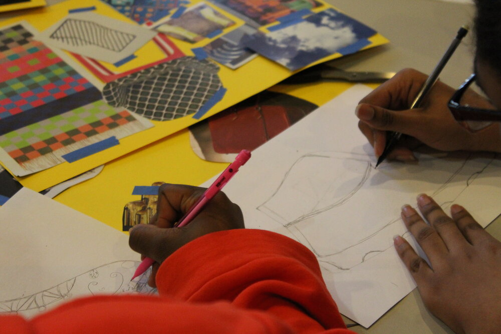  Students designing on shoe outlines. Credit: Mae Morris 