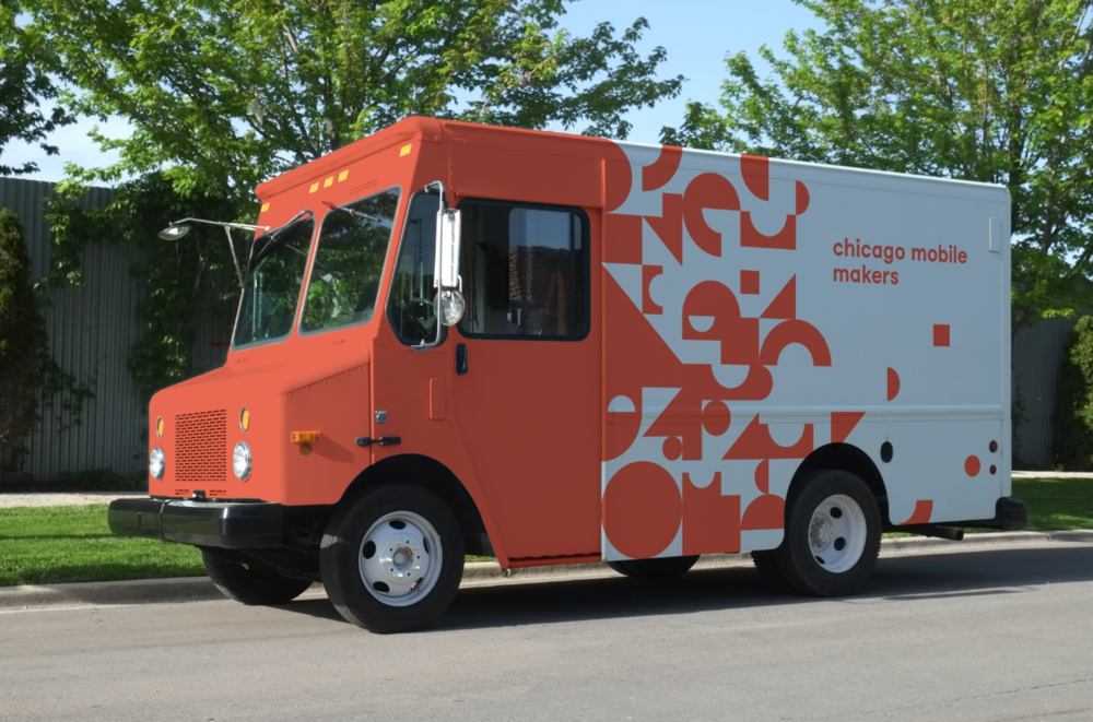  An orange and white truck with “Chicago Moblie Makers” on the side.  