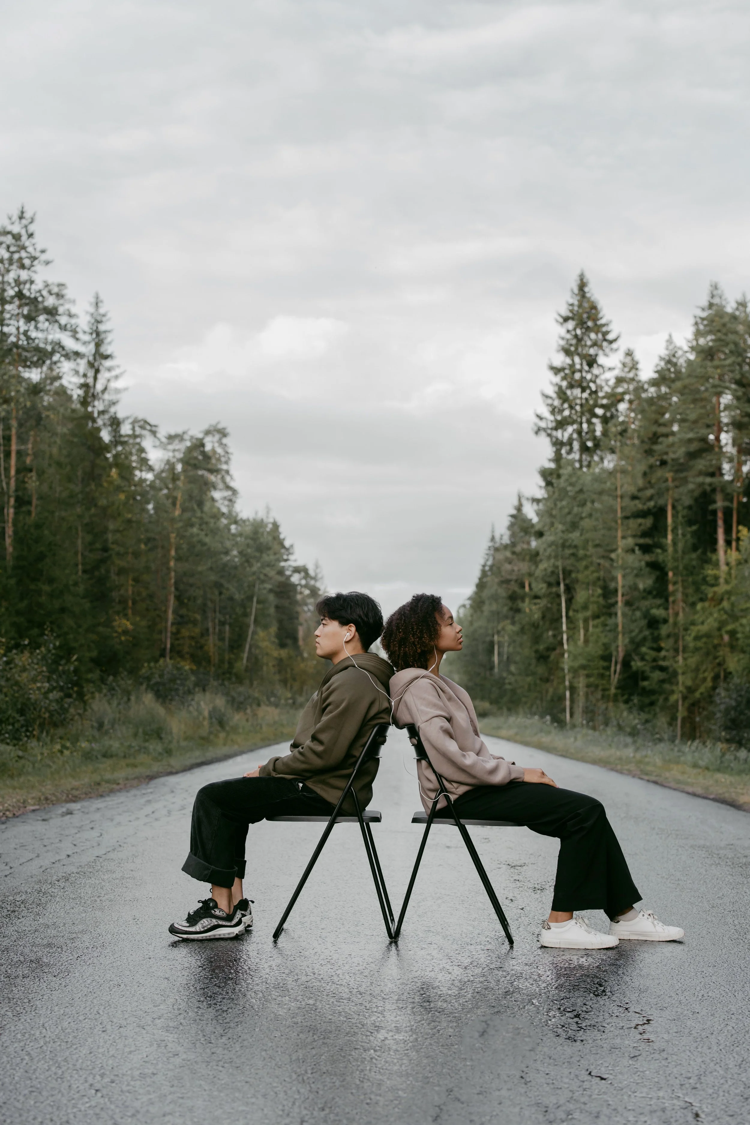 Couple sitting in the street, listening to music