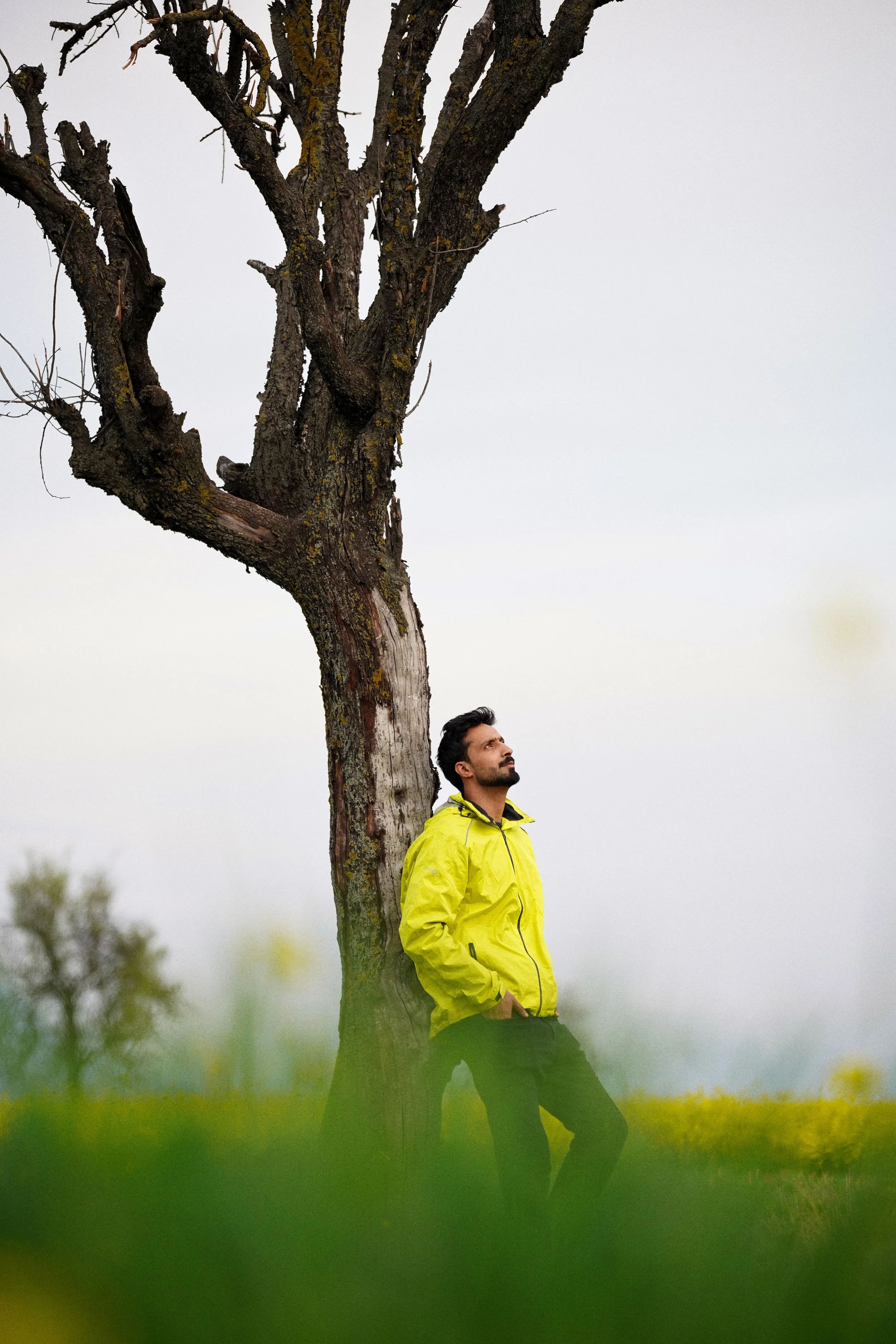 Man leaning against a tree