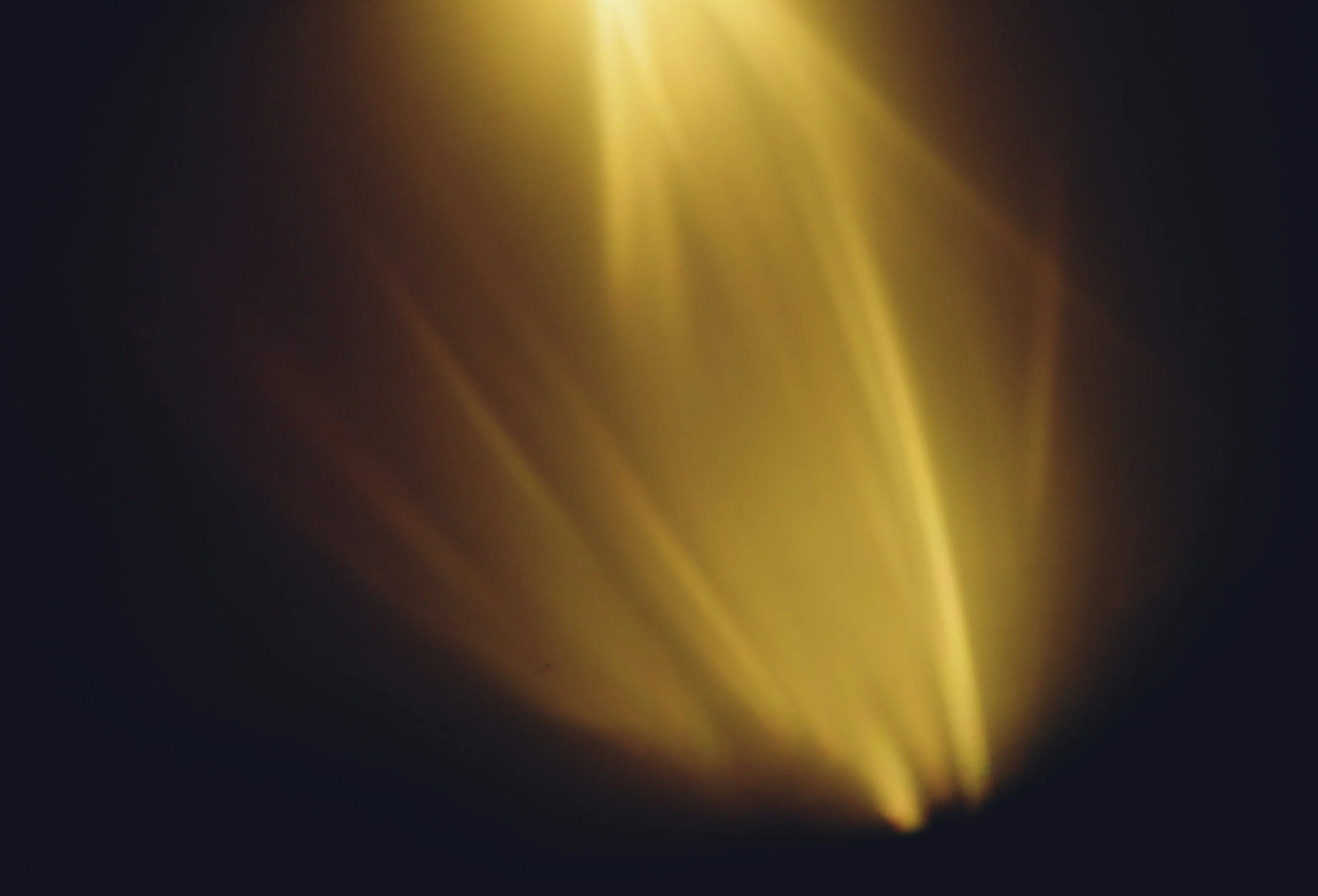 Two beams of golden celestial light piercing the night sky, illuminating stars and cosmic clouds in a dramatic space scene