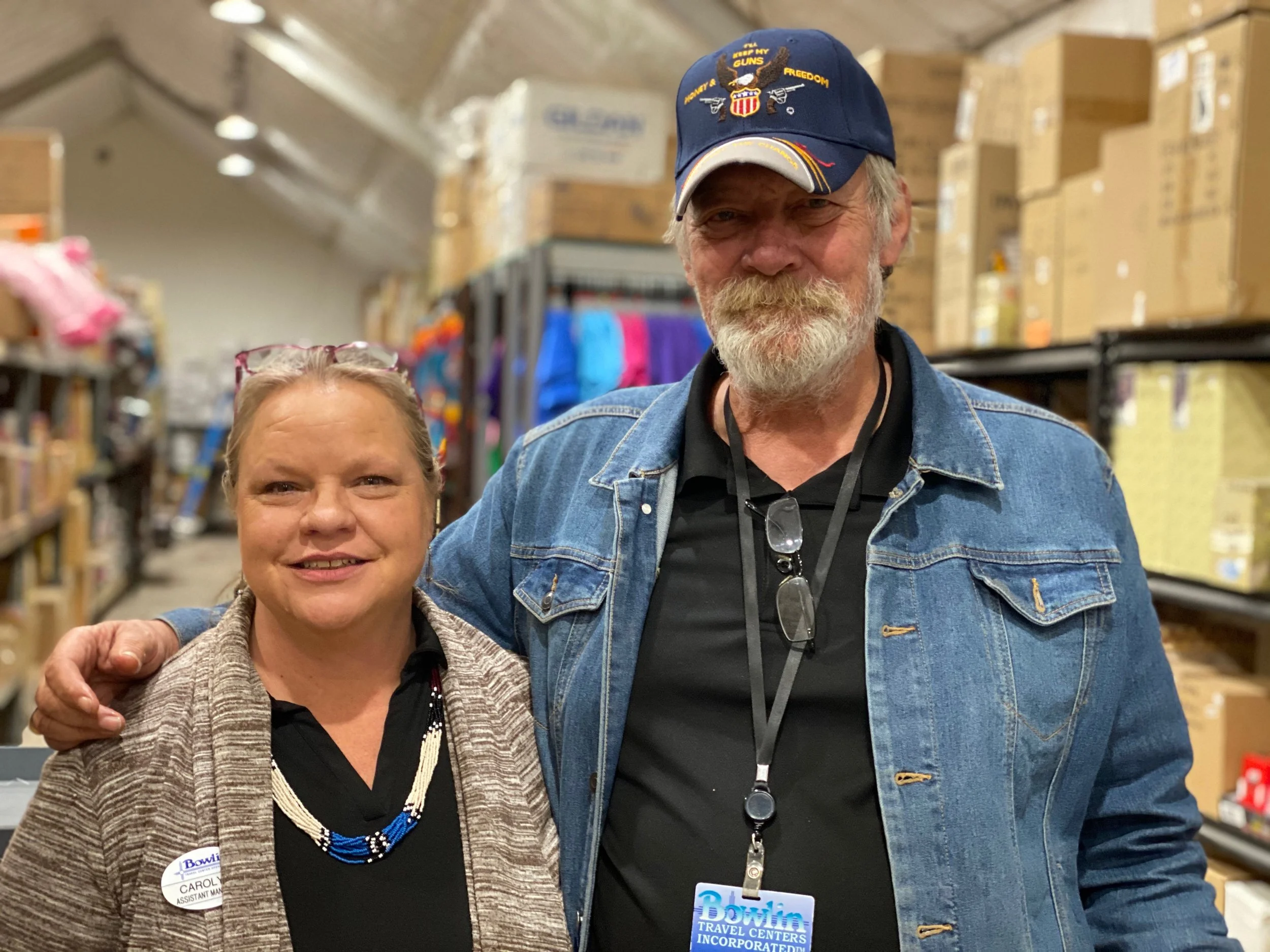 Managers Carolyn and Phil smiling in warehouse