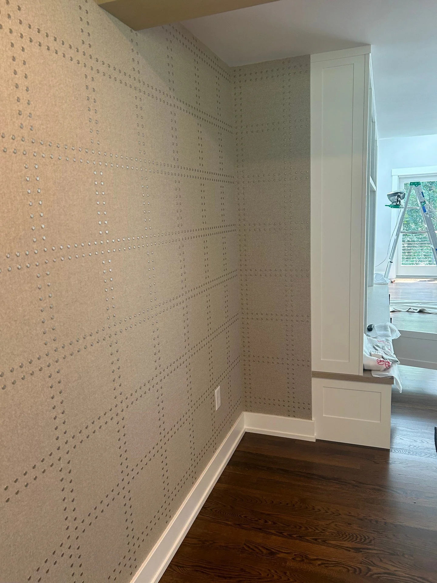 The dining room at Meadowlight before the furniture arrives &mdash; and already, the room has presence.⁠
⁠
The wallcovering wraps every surface in a warm taupe-grey ground with an embossed dot-grid pattern: rows of raised nailhead-like dots forming l