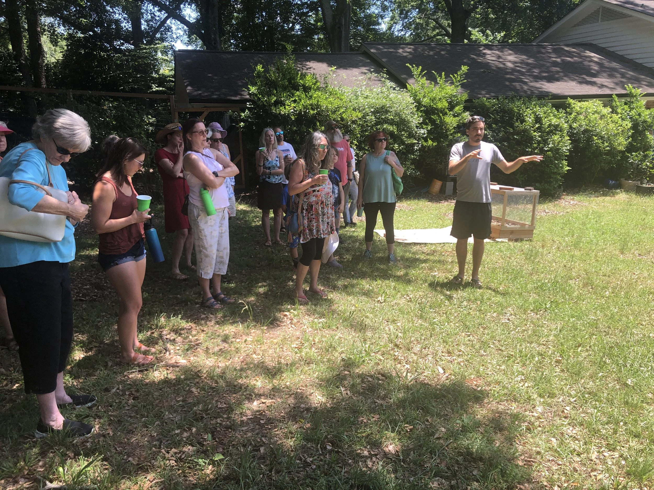  Kerem Kilic gave tours of his early-stage food forest and permaculture practices, while kids painted butterfly feeders in the shade. 