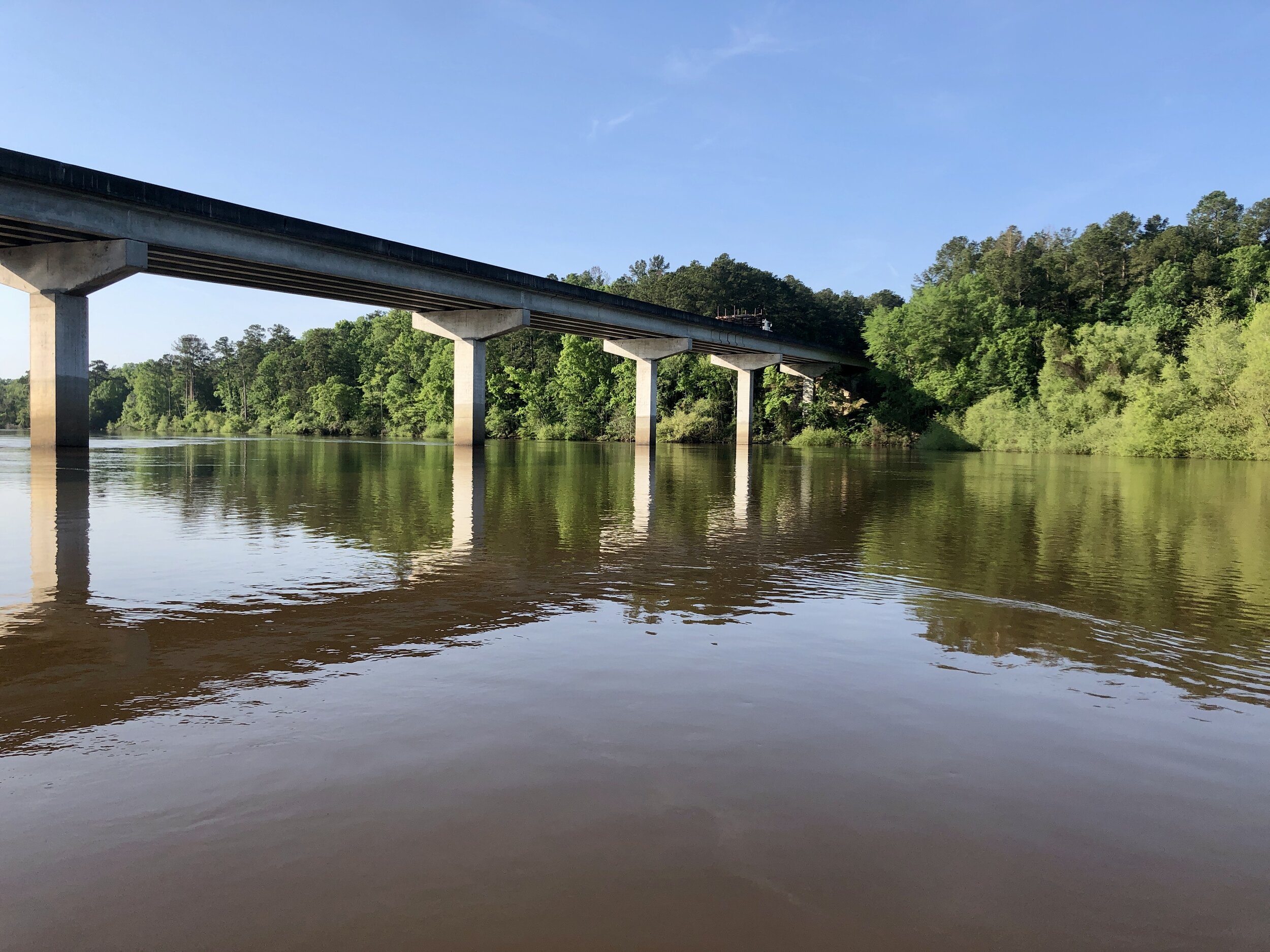 Logging trucks blast across the Hwy 169/121 bridge every few minutes.