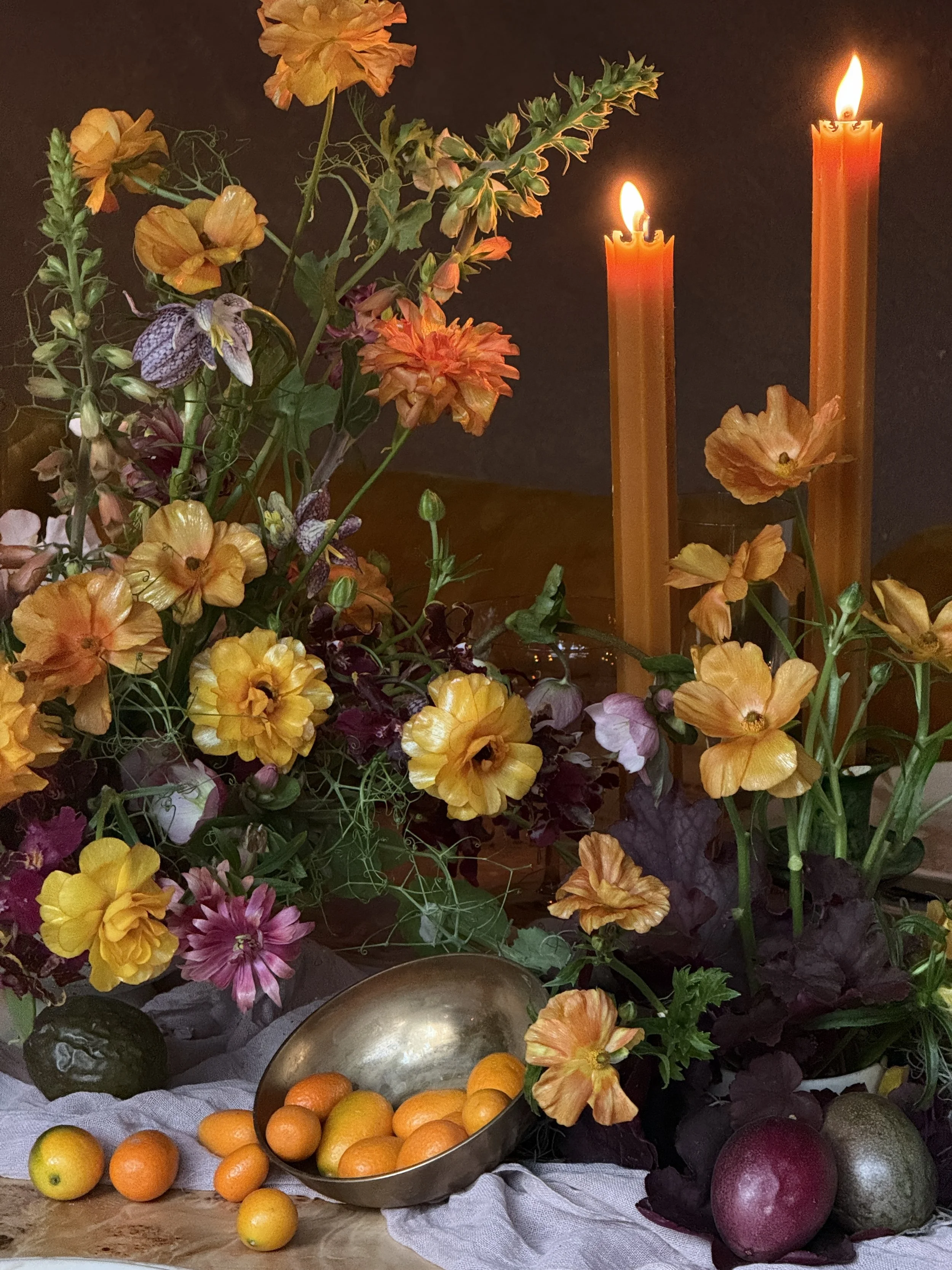 Floral Tablescape by New England floral designer Lucy Blooms. Designed using seasonal flowers in an orange and plum color palette.