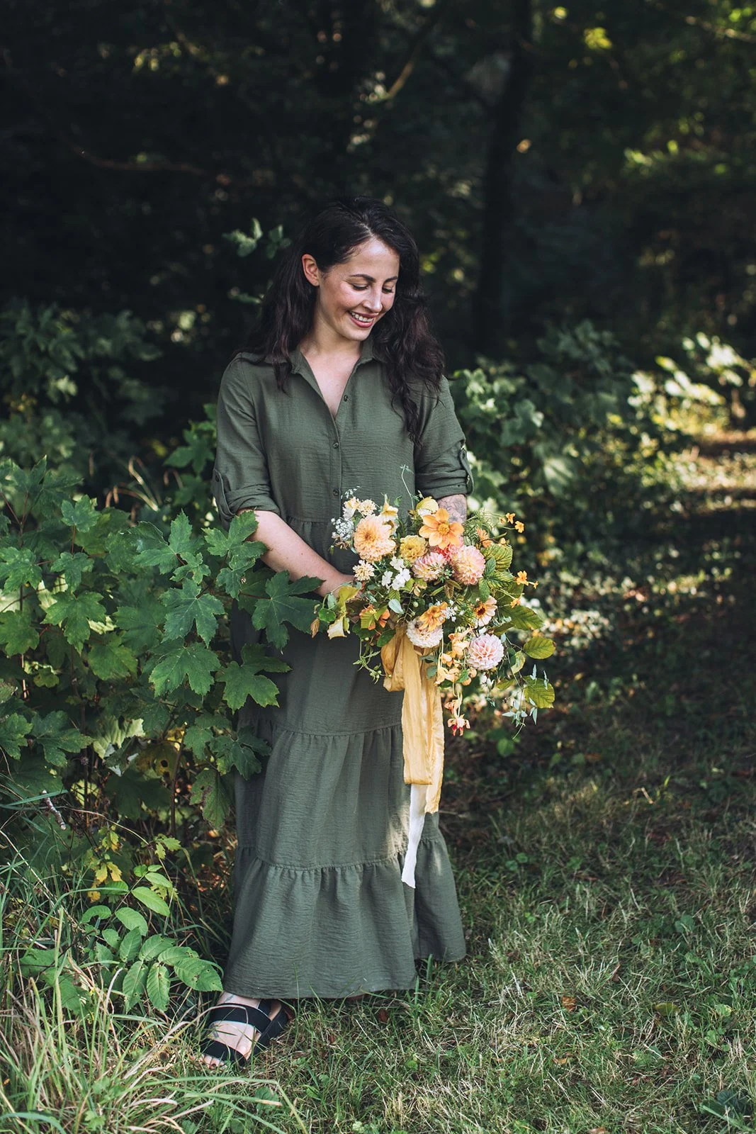 Lucy Blooms holding bridal bouquet designed with seasonal flowers