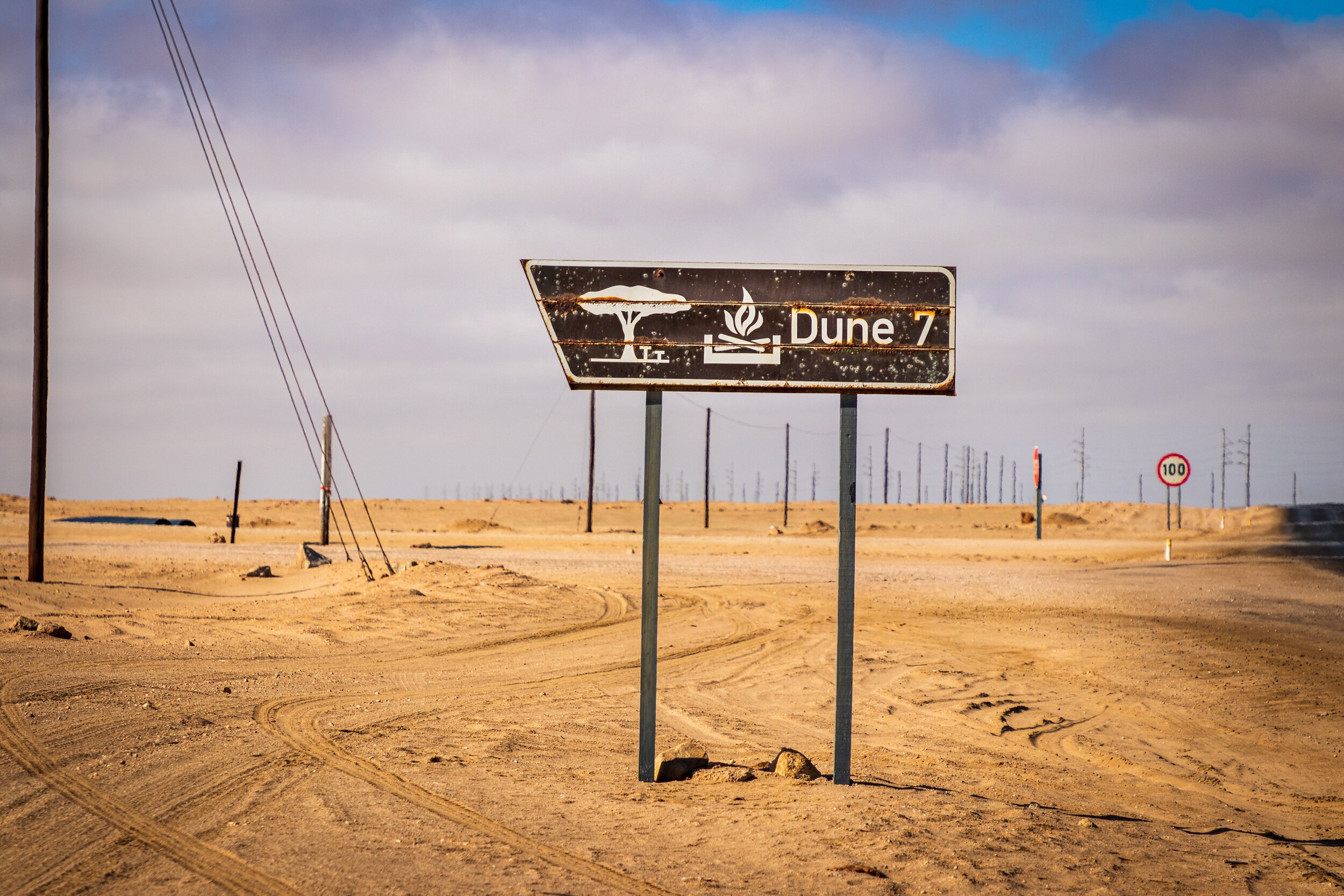 street sign displaying "dune 7" in the sand in namibia