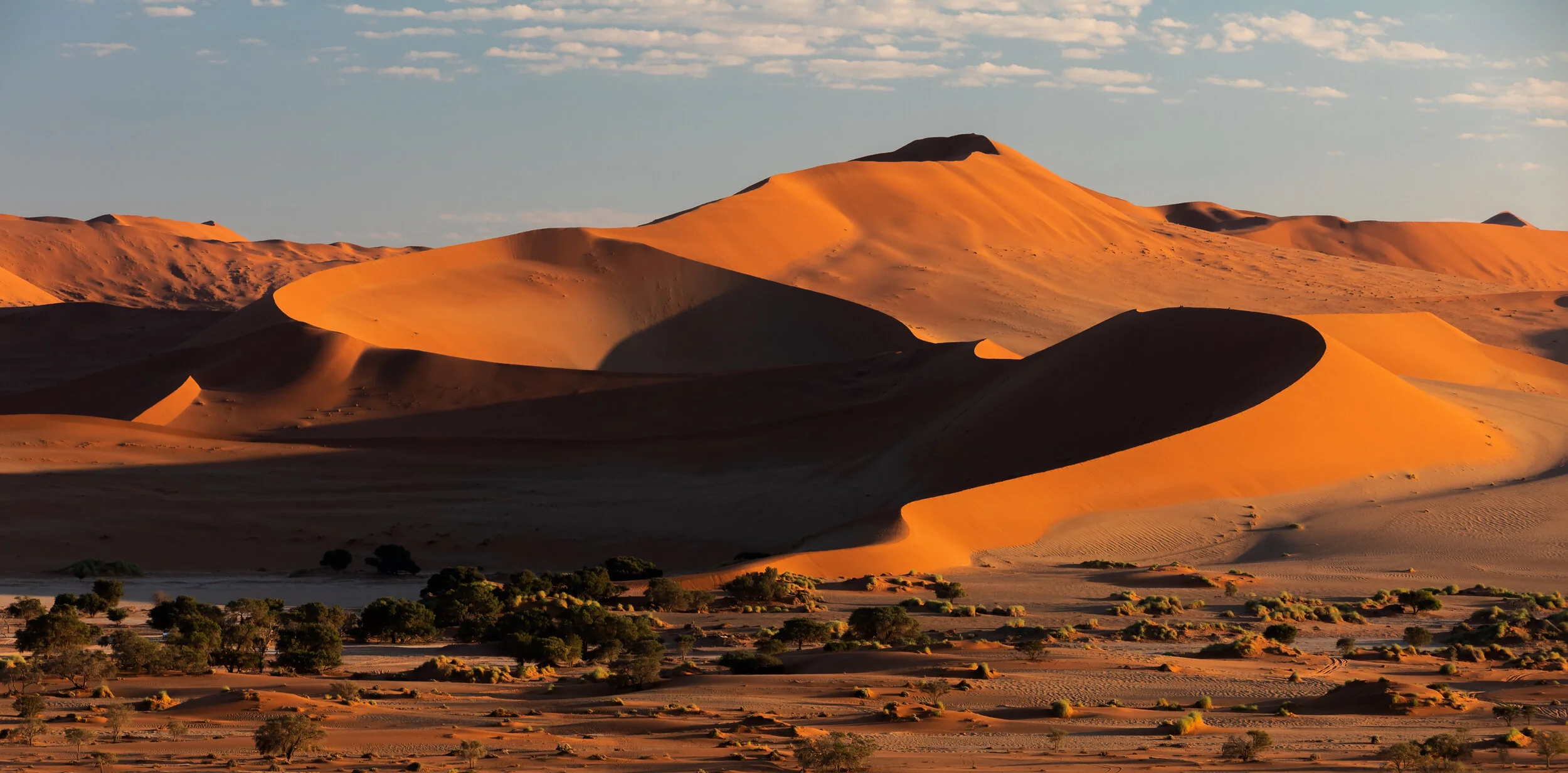 Shadows fall on the red sand dunes in Sossusvlei, Namibia
