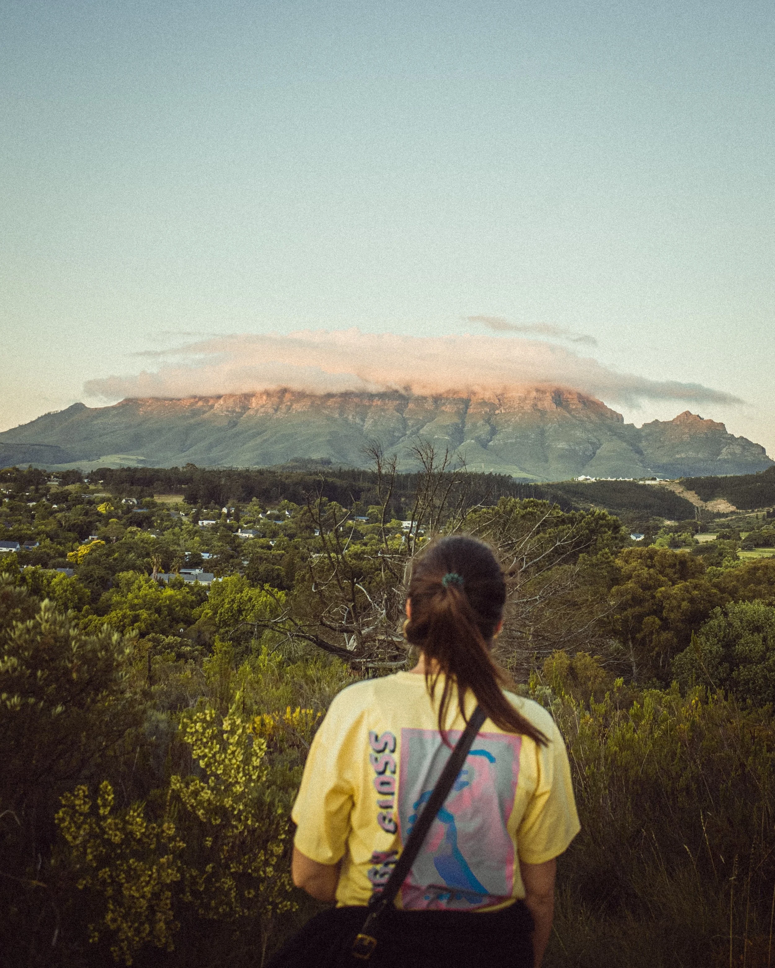 Woman looking at the mountains and vegetation view while on a hike