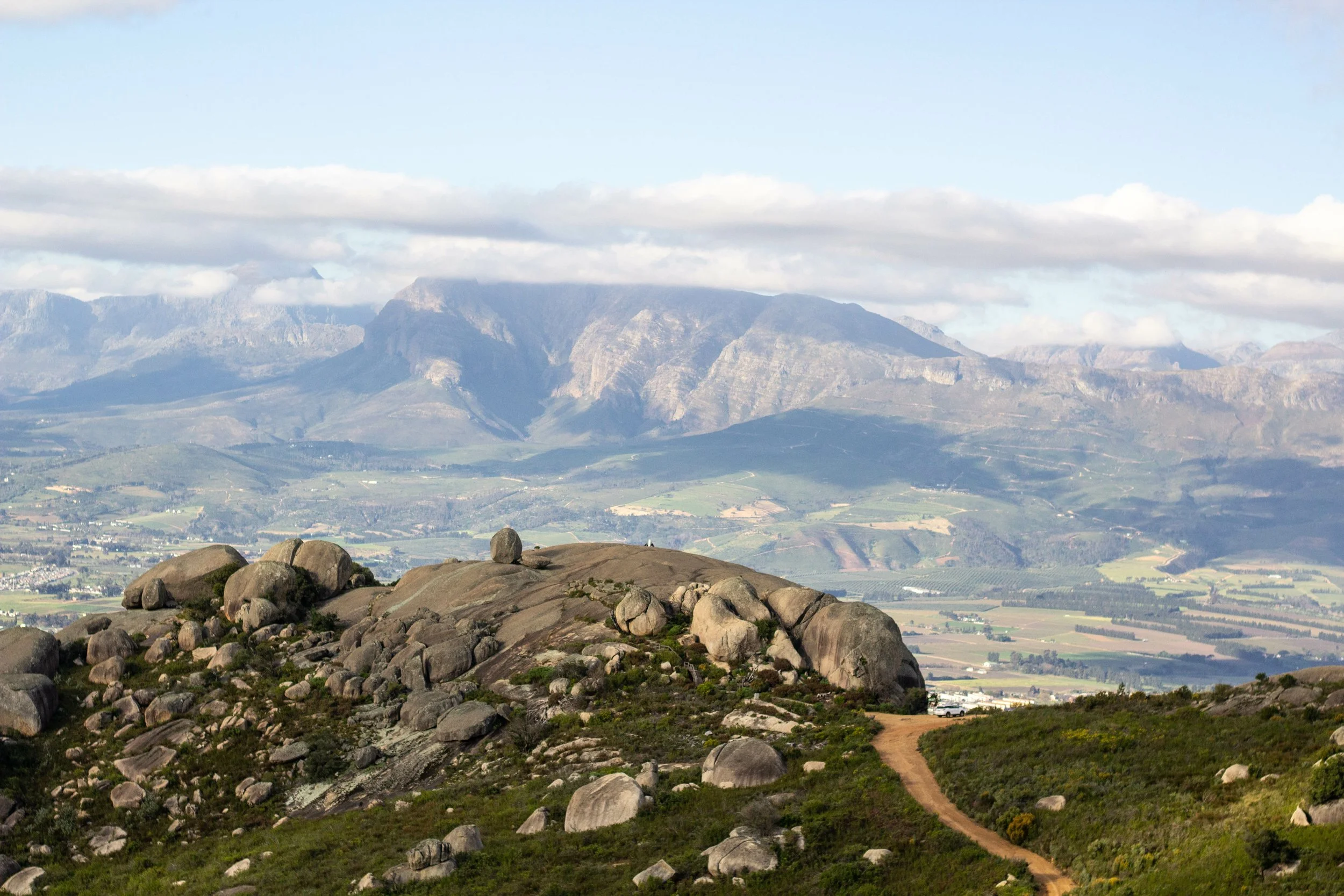 Hiking trail overlooking mountains and green landscape