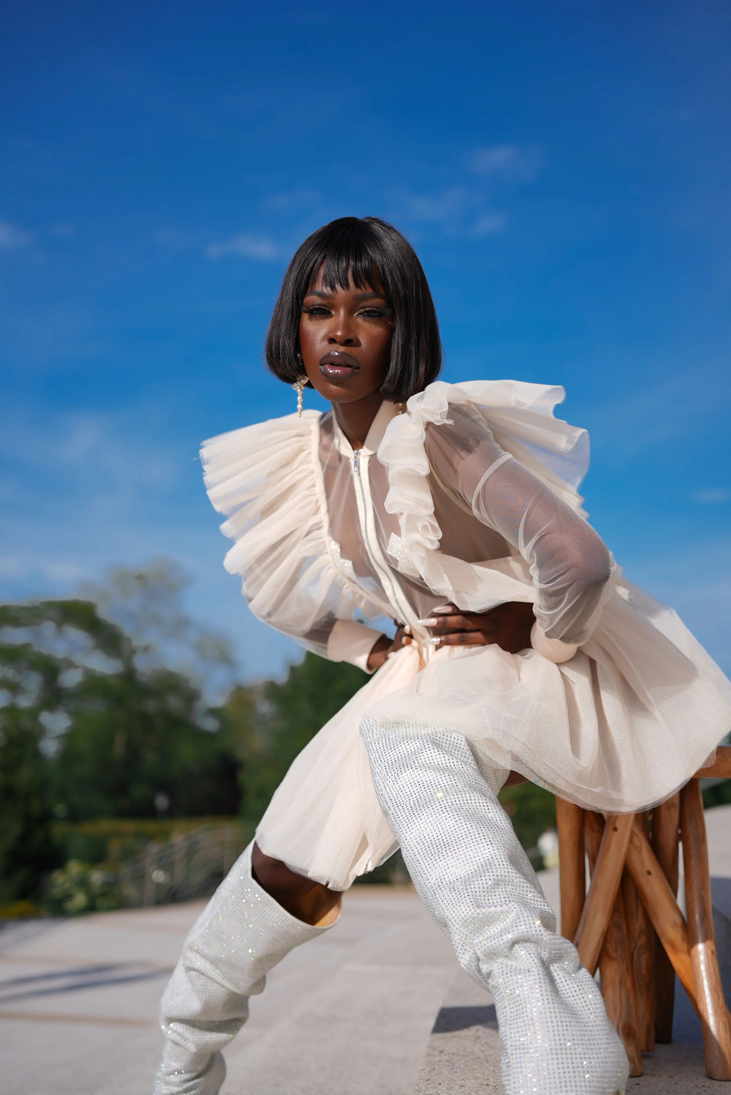 Queen Drie sitting on a  stool on the Bahai Staircase in Evanston, Illinois