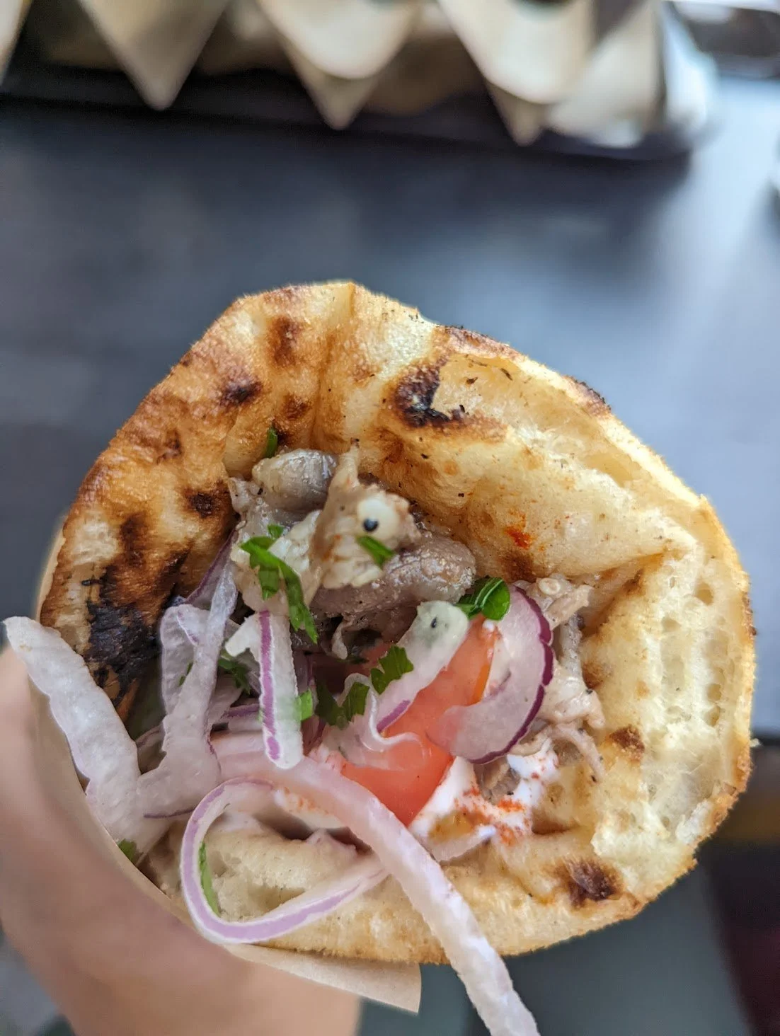 Hand holding a gyros