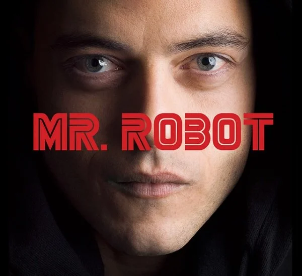 Close-up of a man's face with blue eyes, with the title 'MR. ROBOT' in bold red letters overlaying his face.
