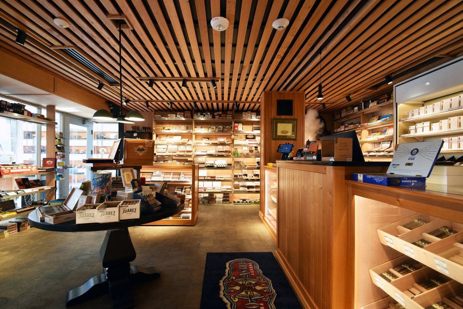 Wood-lined Tobacco Leaf shop with cigar displays and a sales counter