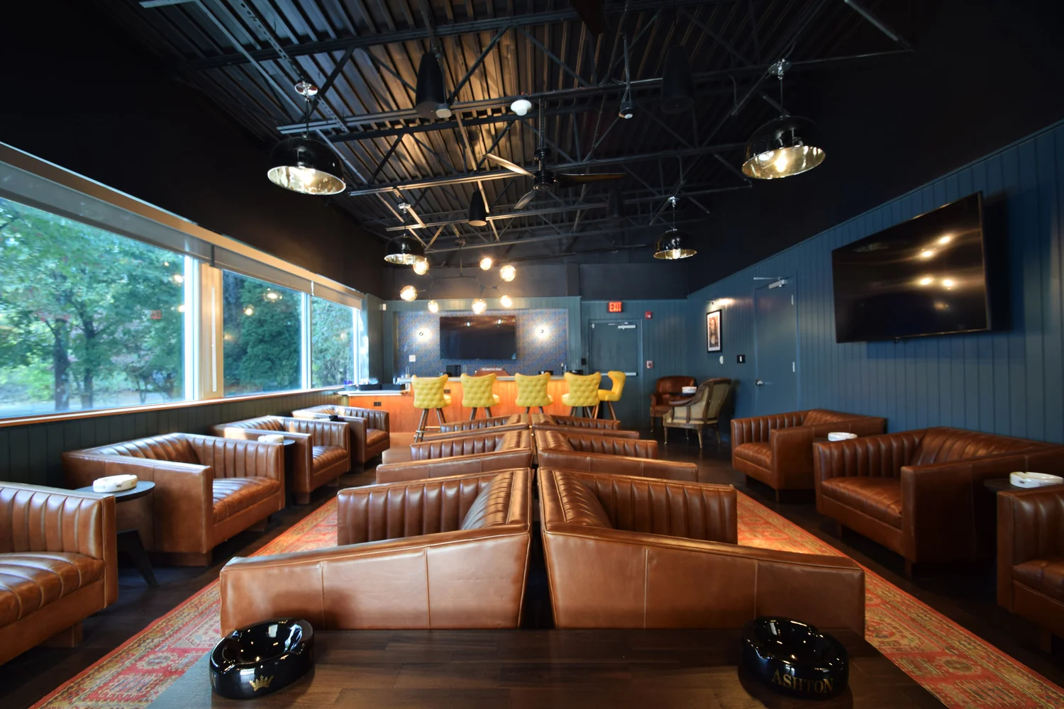 Leather seating and blue walls in the Tobacco Leaf lounge
