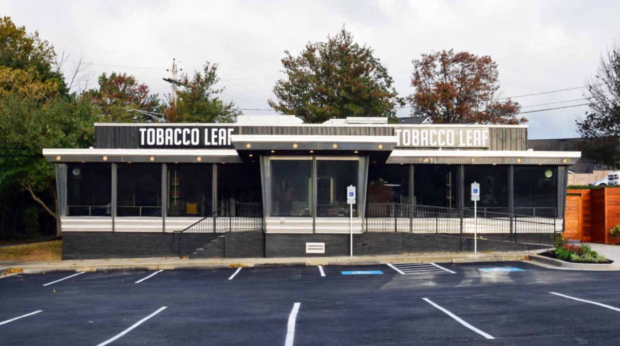 Front of Tobacco Leaf in Jessup, with shop signs, central entrance and access ramp