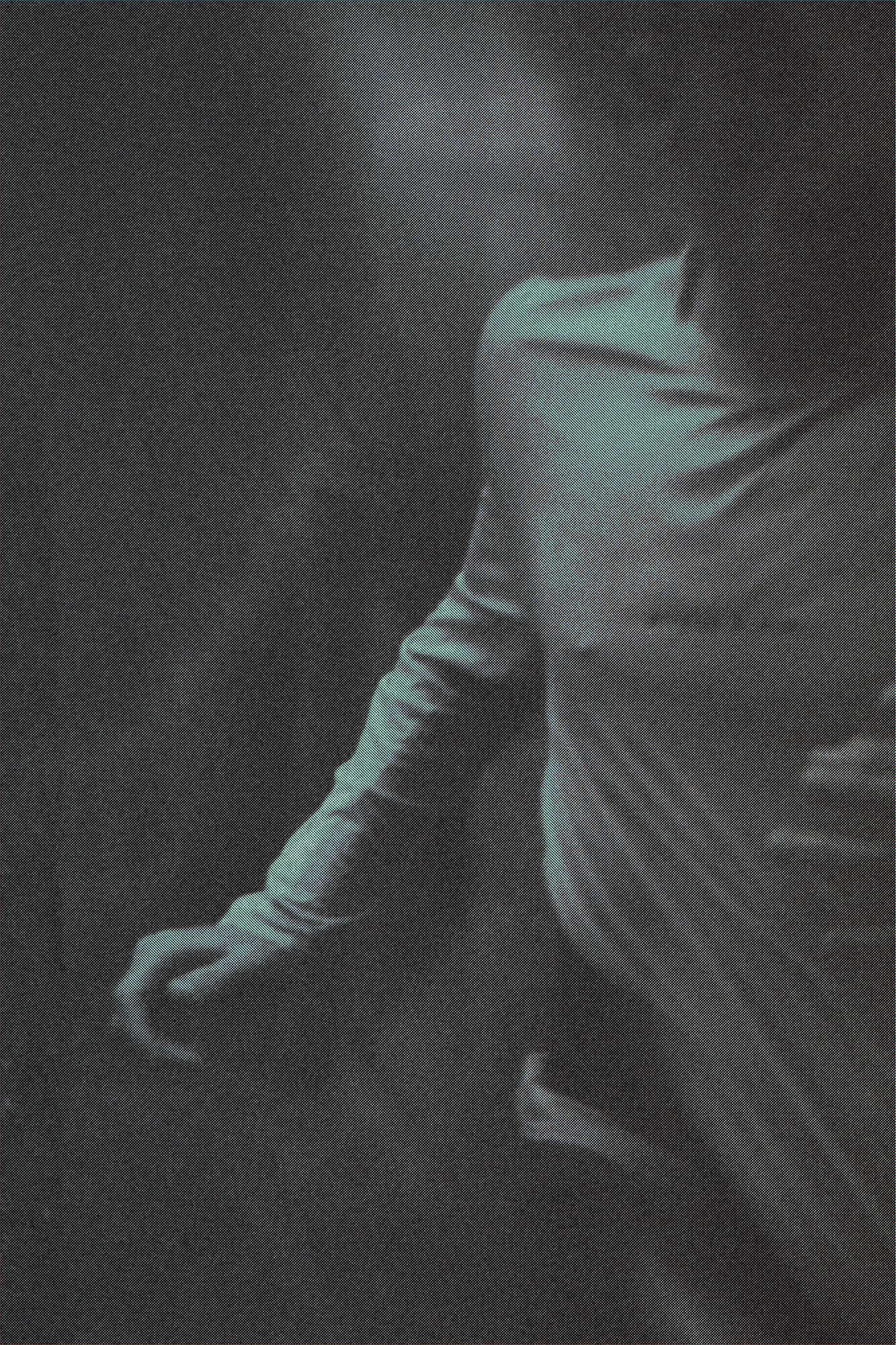 Person wearing a long-sleeve shirt, standing against a dark background, with focus on their torso and arm.