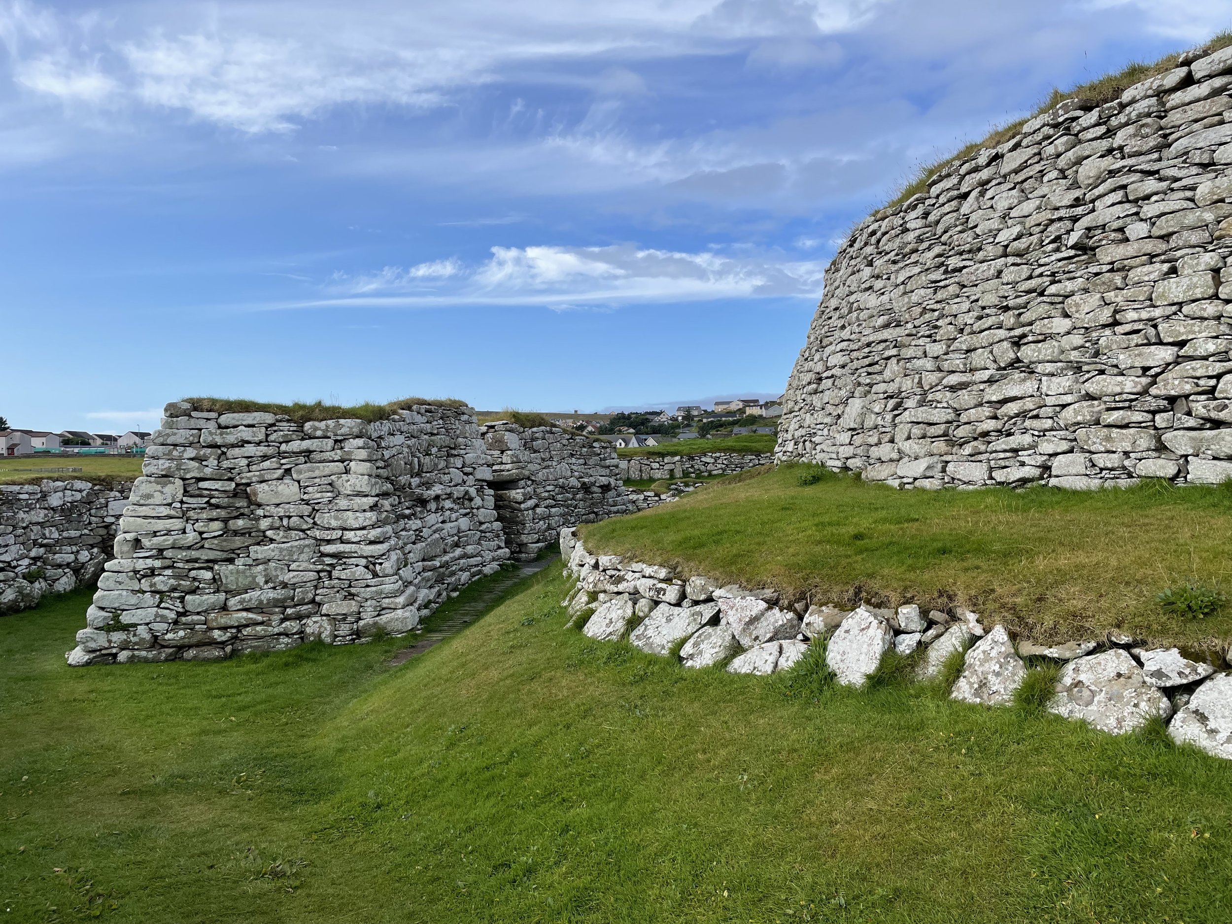 Stone ruins with grassy areas and blue sky