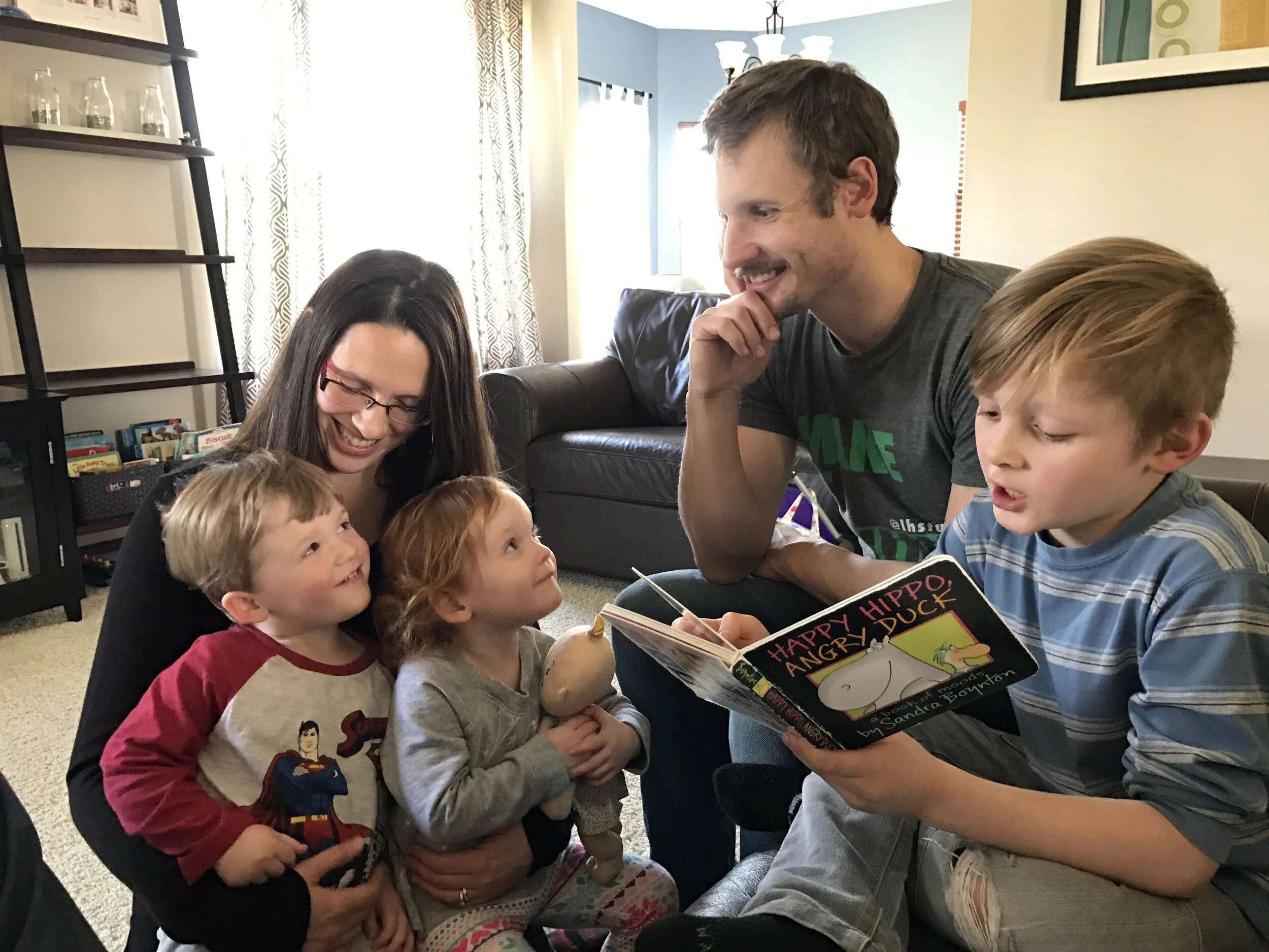 Copy of Silas reading to twins.JPG