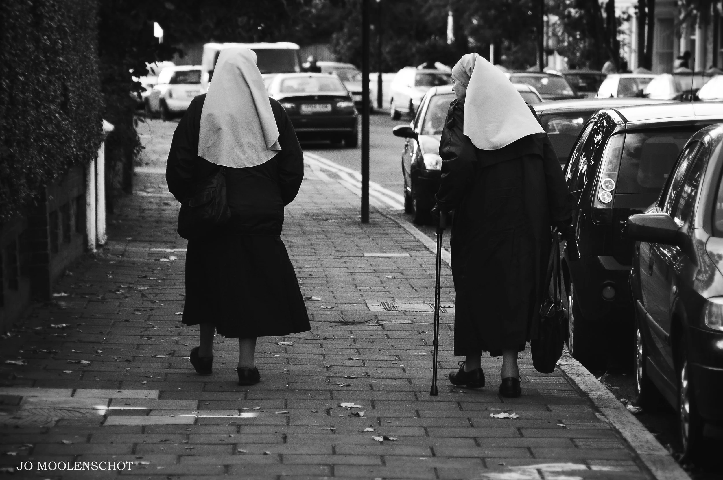Two nuns walking and talking together London street photography.jpg