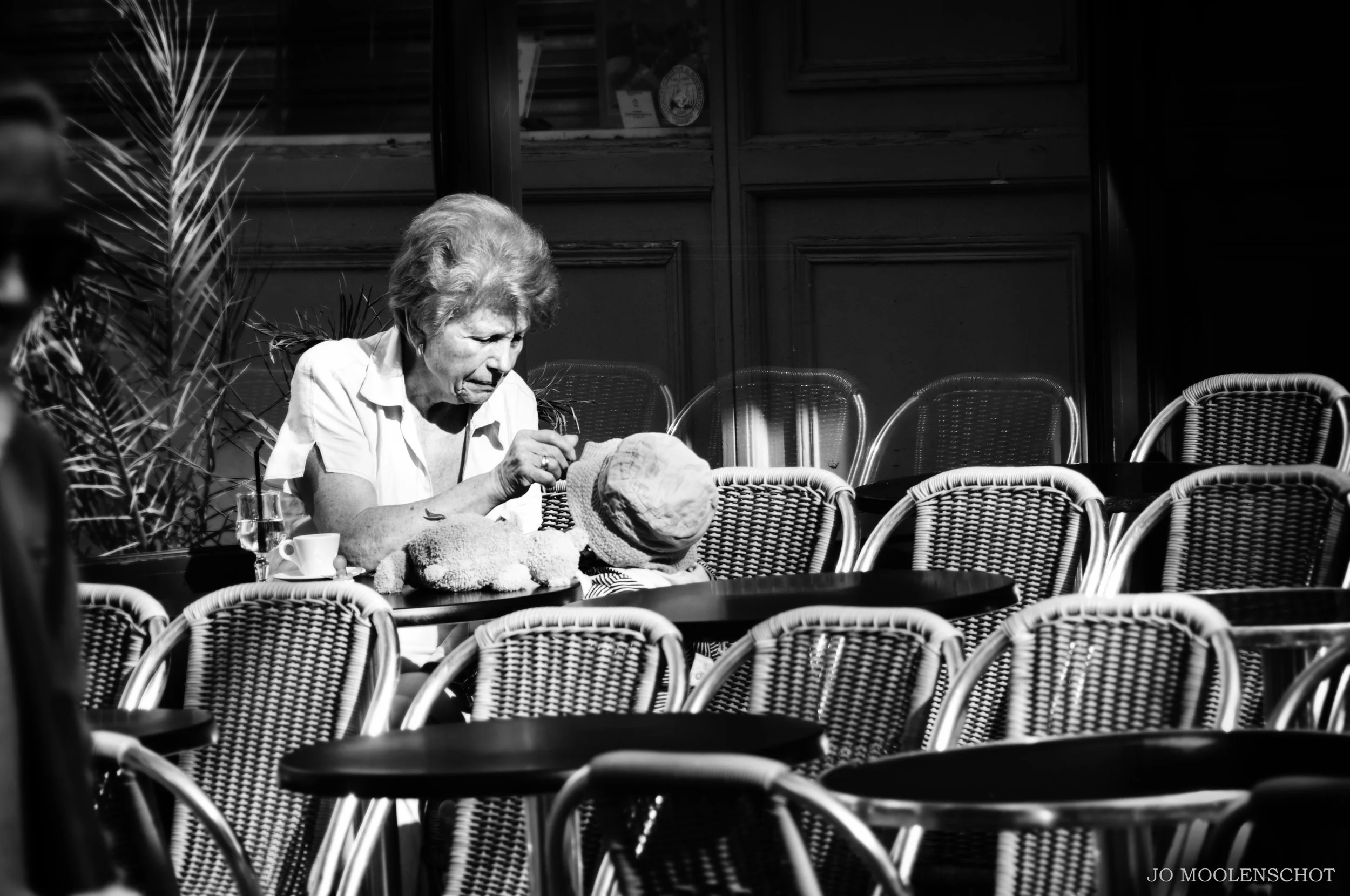 Grandmother feeding baby outside Paris cafe street photography Jo Moolenschot.JPG