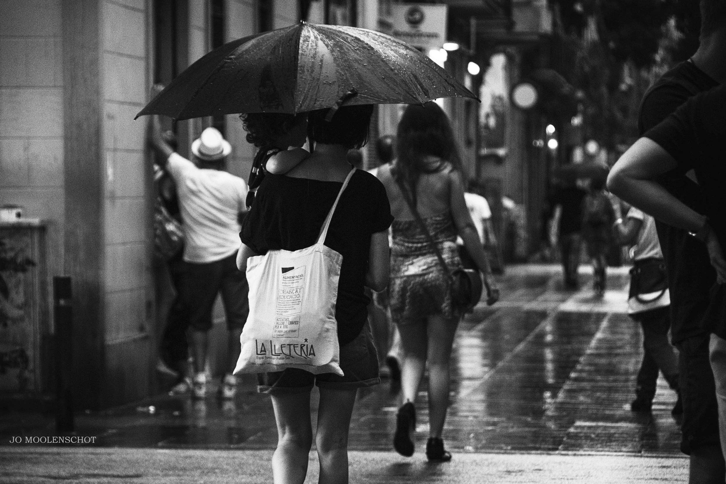 Woman under umbrella with child Barcelona Spain Summer Thunderstorm Jo Moolenschot Street Photography.JPG