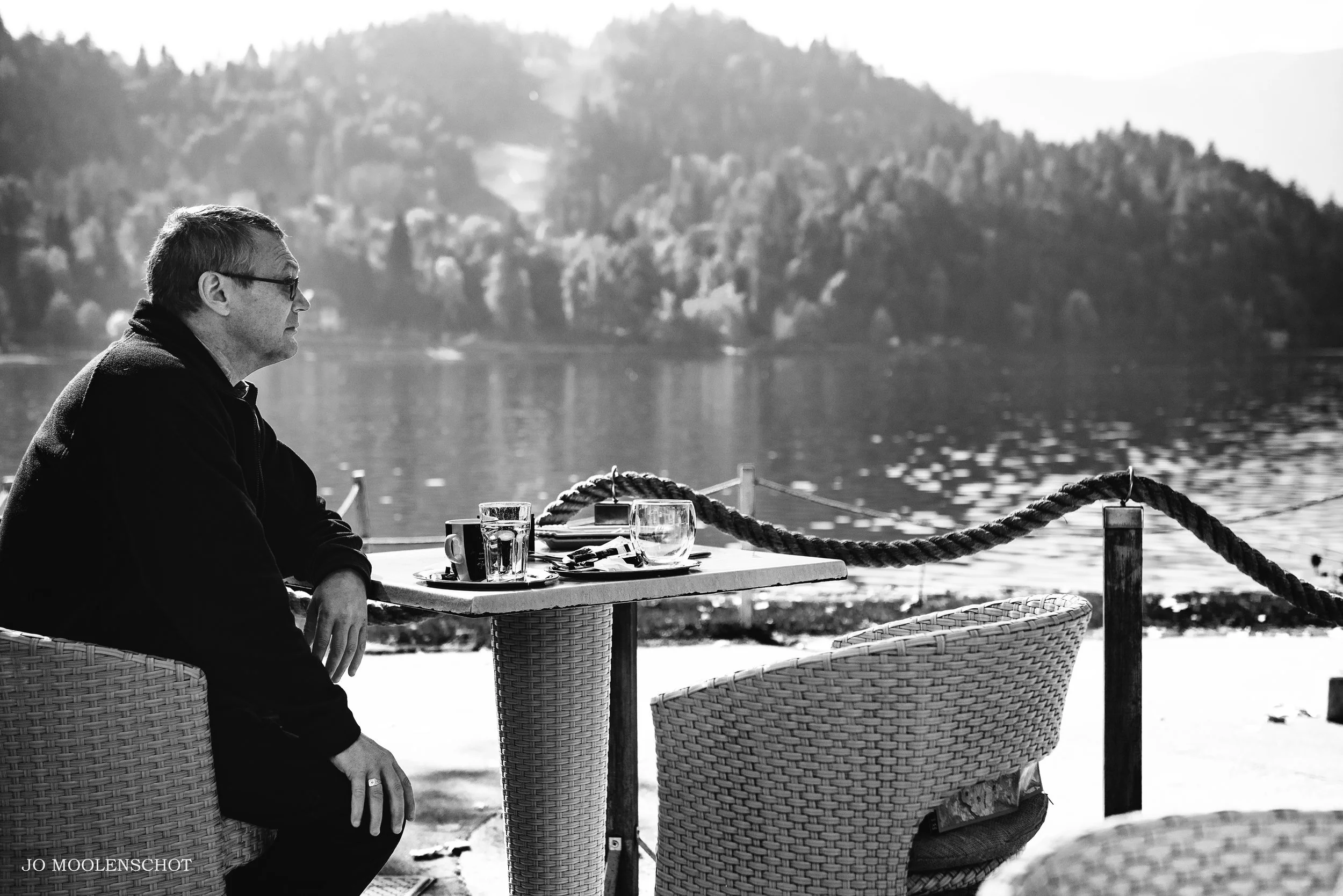 Lake Bled Slovenia Man sitting next to the lake Street Photography by Jo Moolenschot09.jpg
