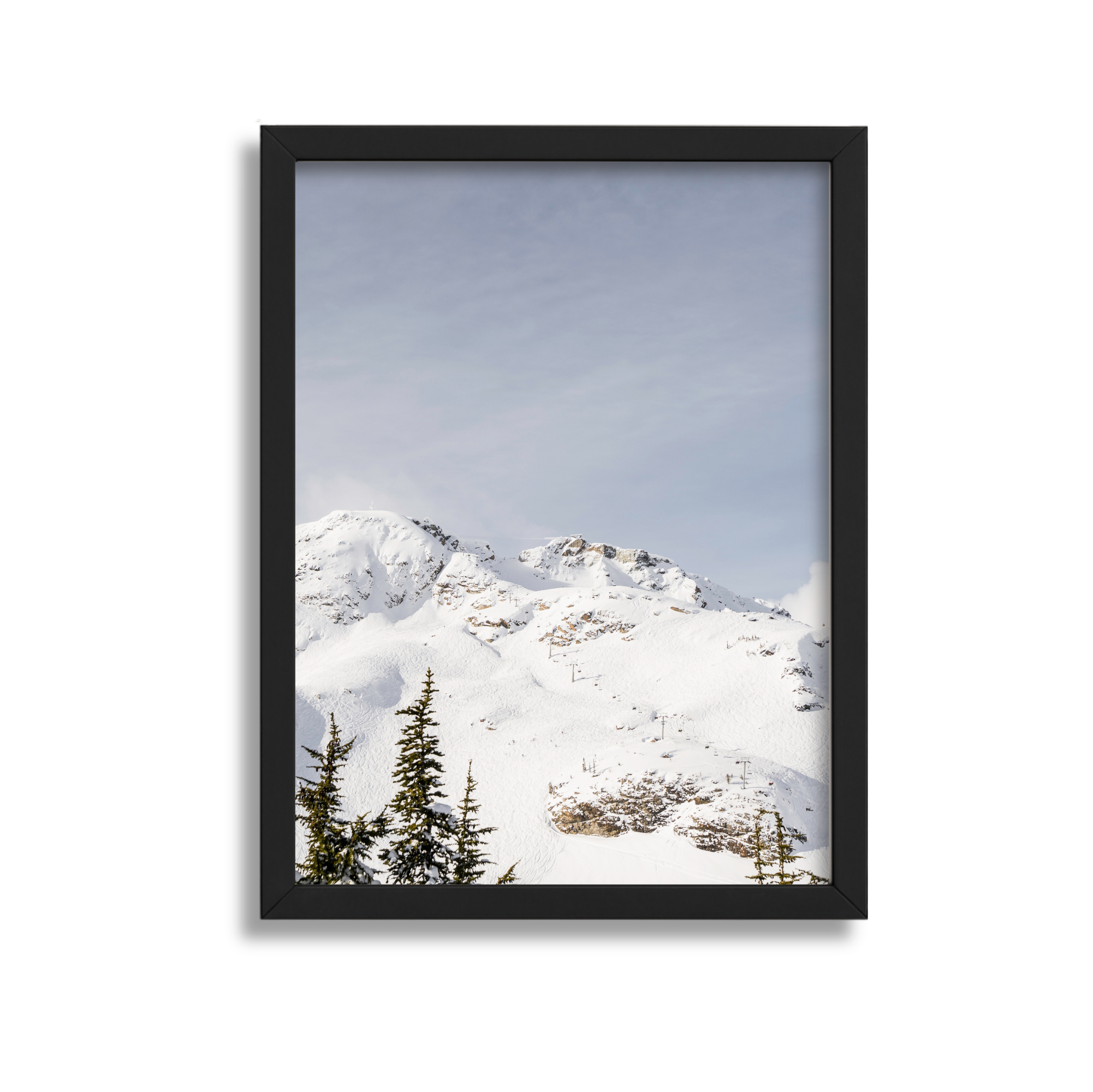 Snow-covered mountain landscape seen through a black picture frame.