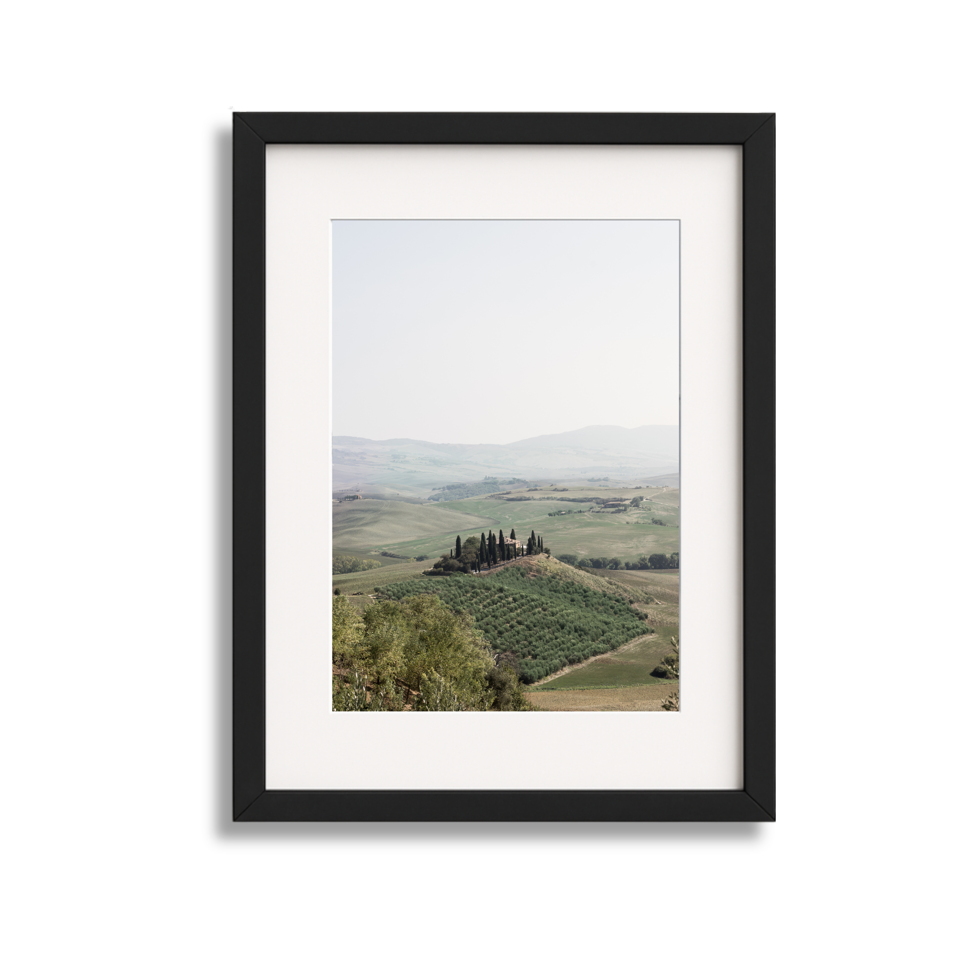 Photograph of rolling hills and landscape framed in a black picture frame