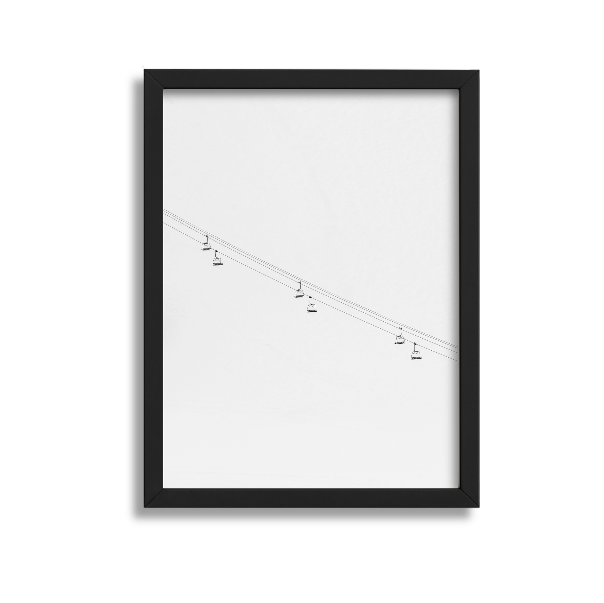 A framed illustration of a cable car line with several small cable cars hanging from the cables.