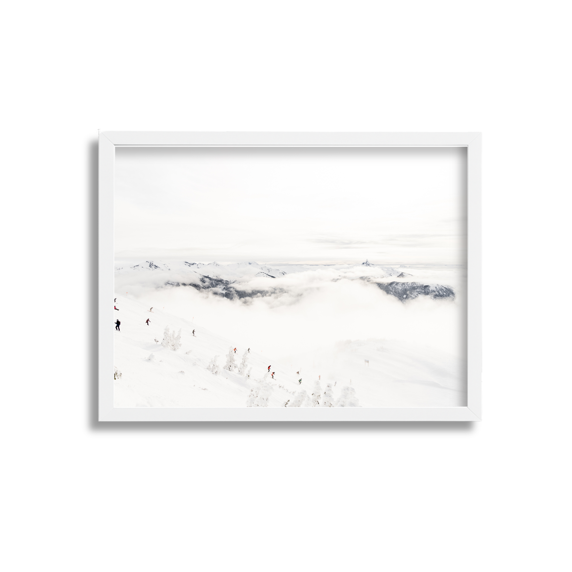 People skiing on a snowy mountain slope with clouds and mountain peaks in the background