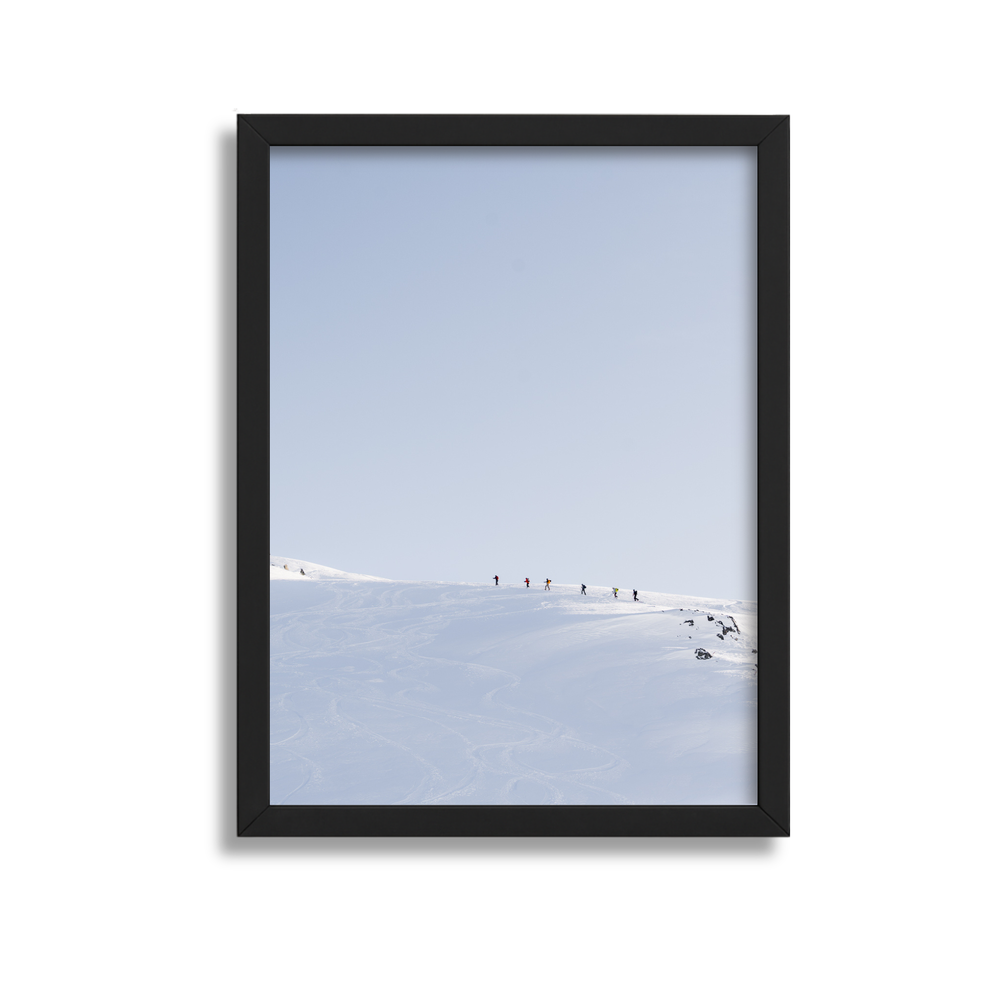 A large framed fine art photography print which shows several backcountry skiers in Whistler Mountain.