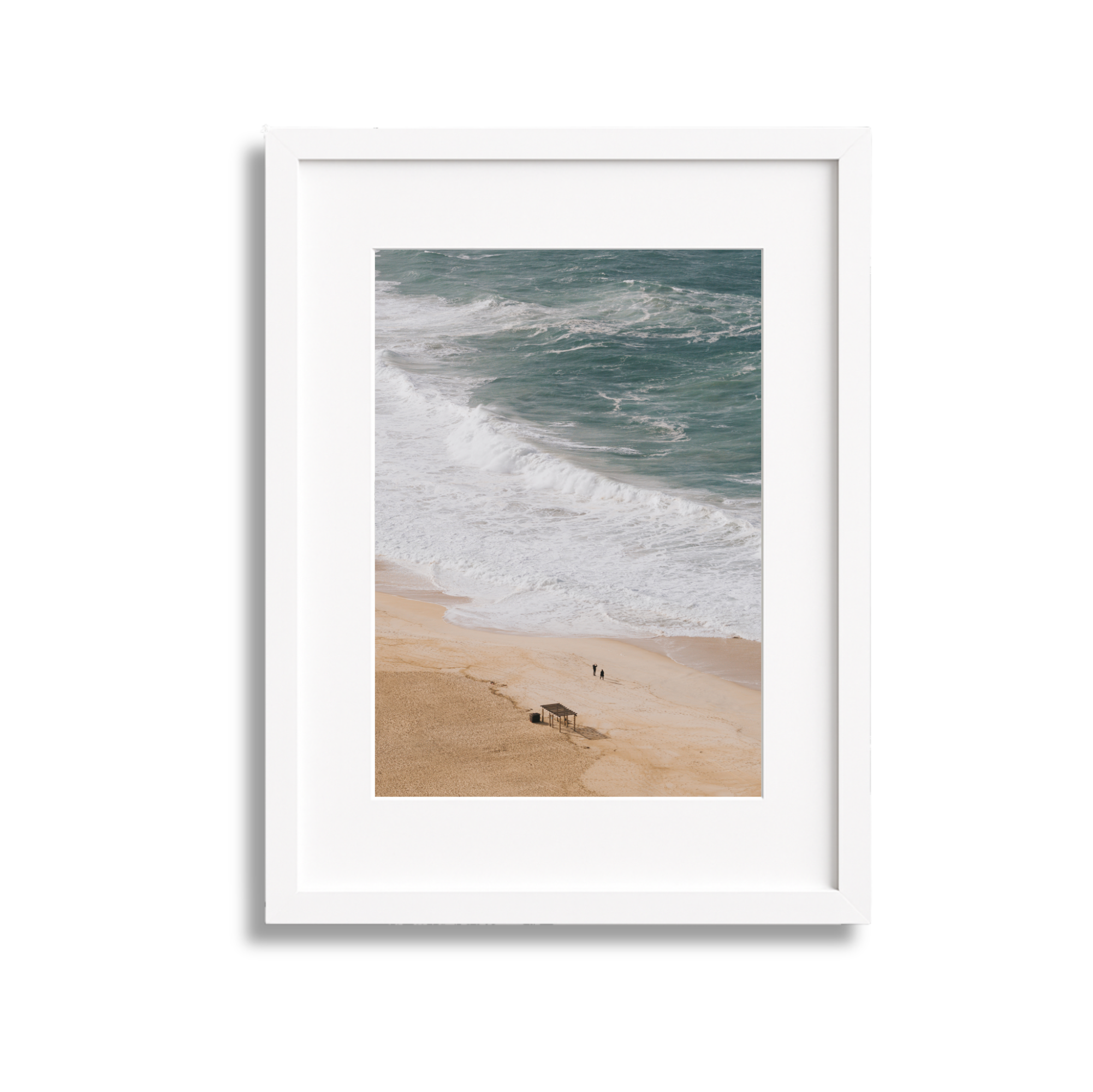 Beach scene with sand, ocean waves, a small shelter, and two people walking along the shoreline.
