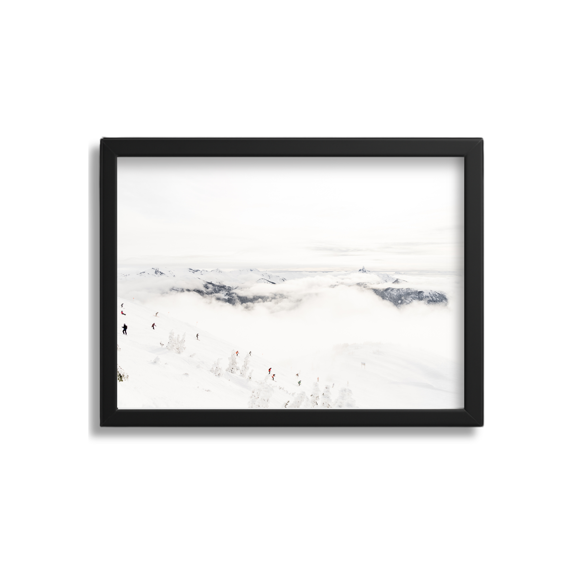 Photograph of a snowy mountain landscape with skiers, clouds, and distant mountain peaks, framed in black.