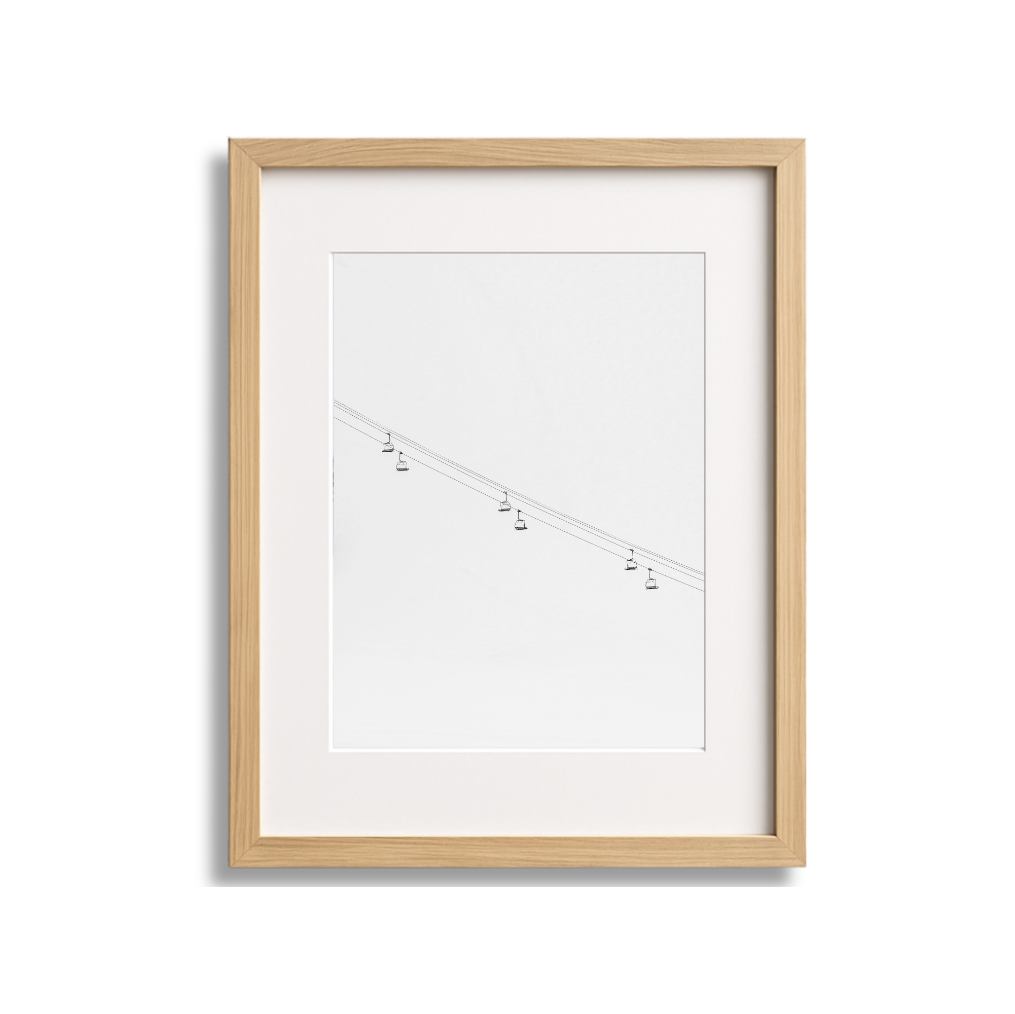 Framed minimalist artwork depicting a simple line drawing of a cable car system with several small cable cars hanging from a diagonal cable on a white background.