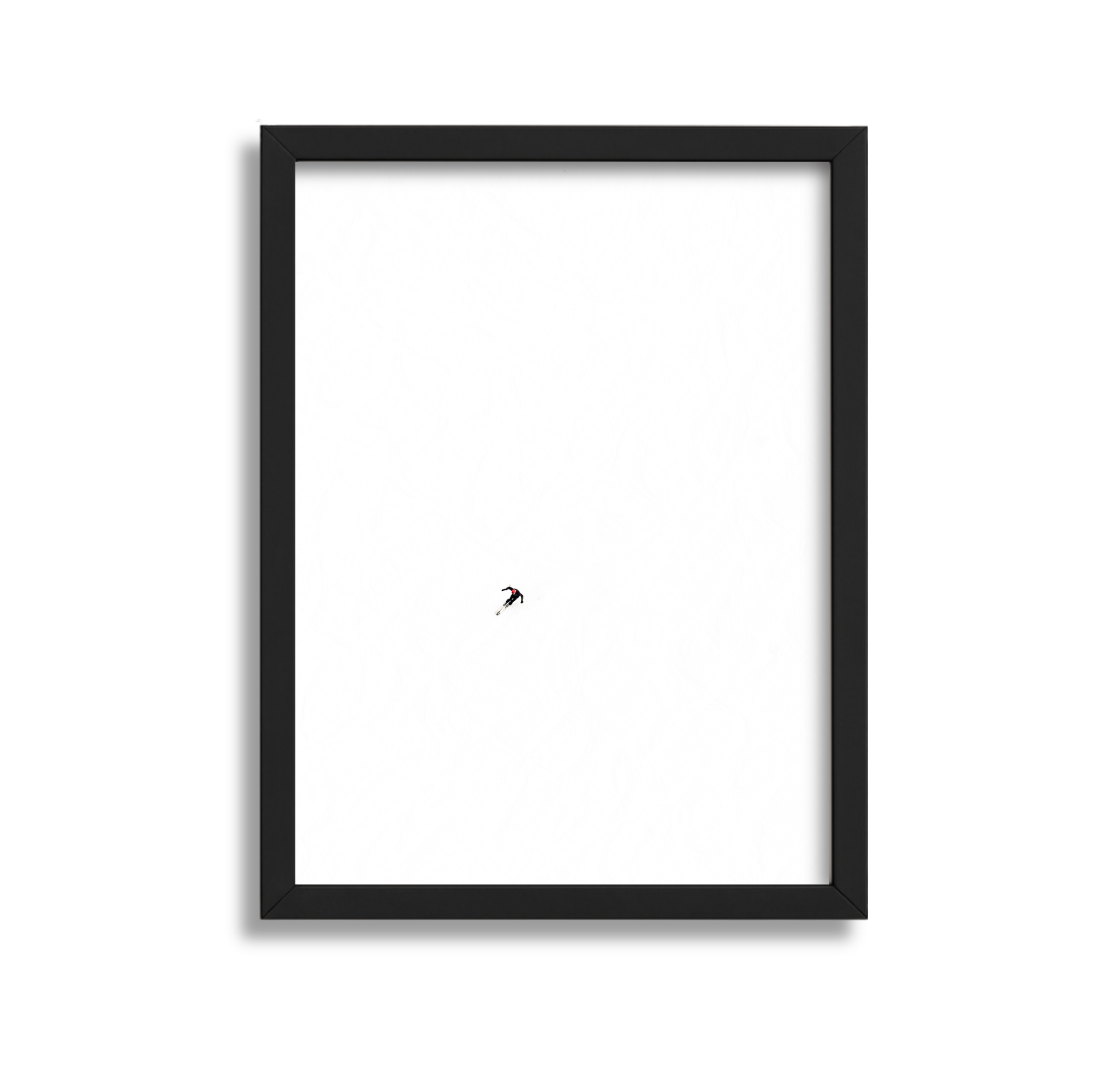 A minimalistic framed picture showing a lone skier descending a snow-covered slope, with a vast white snow expanse surrounding them.