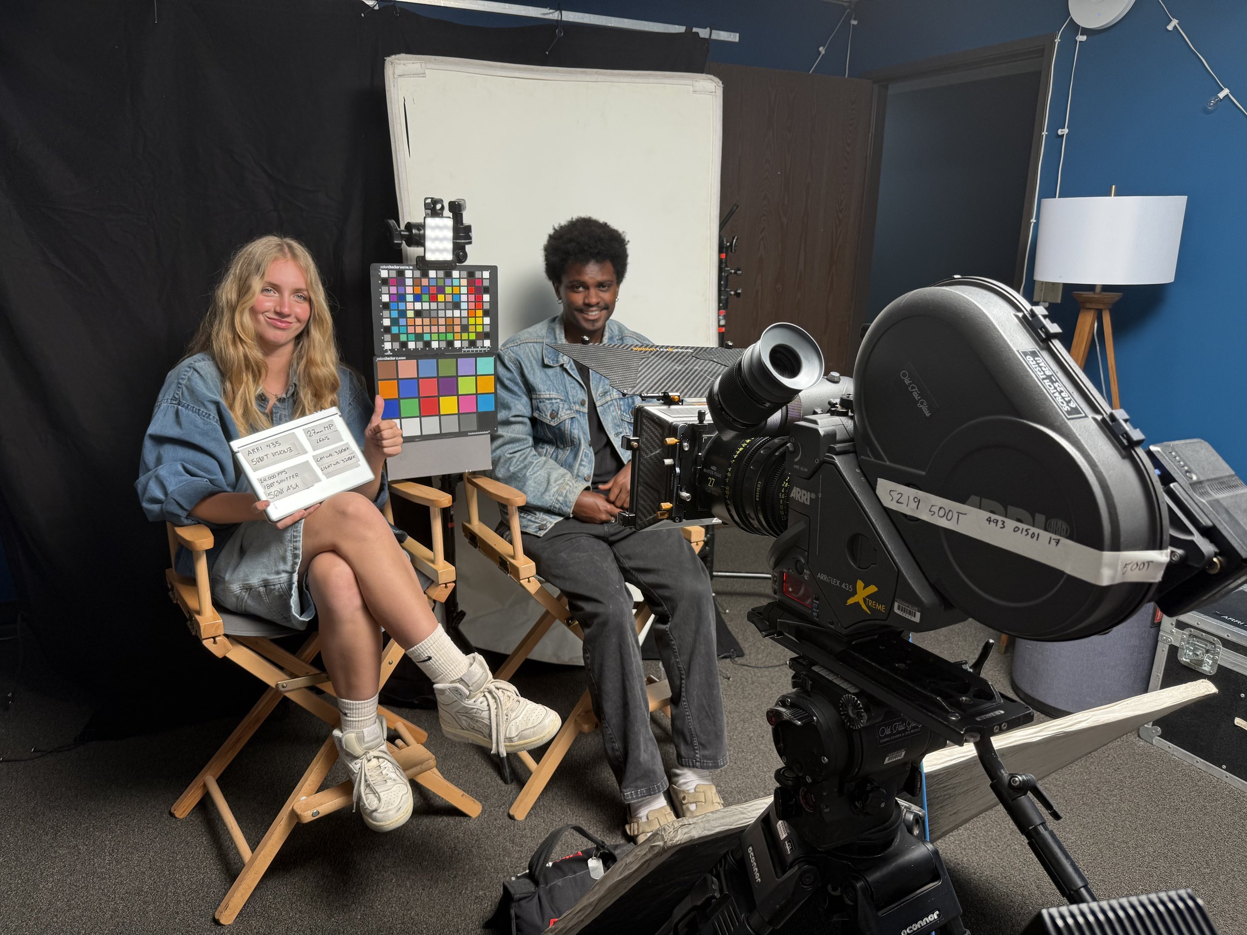 man and woman sat in front of 35mm movie camera for film color grading test