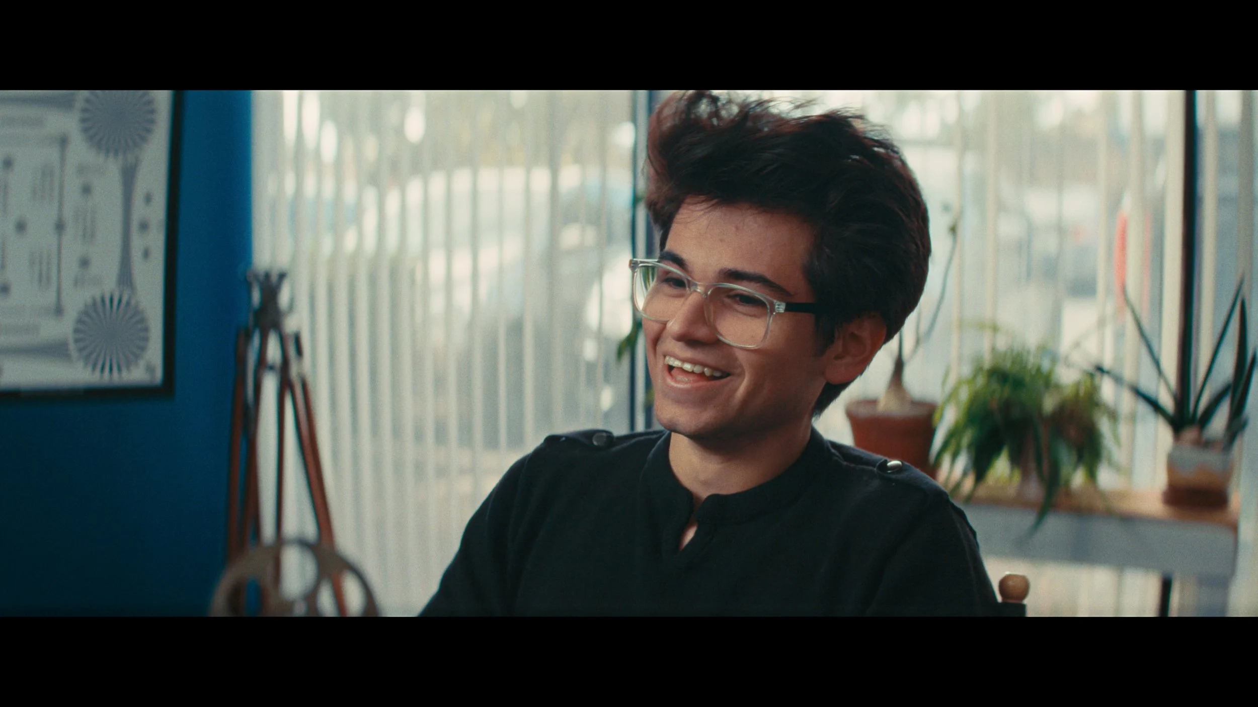 Man smiling in front of window