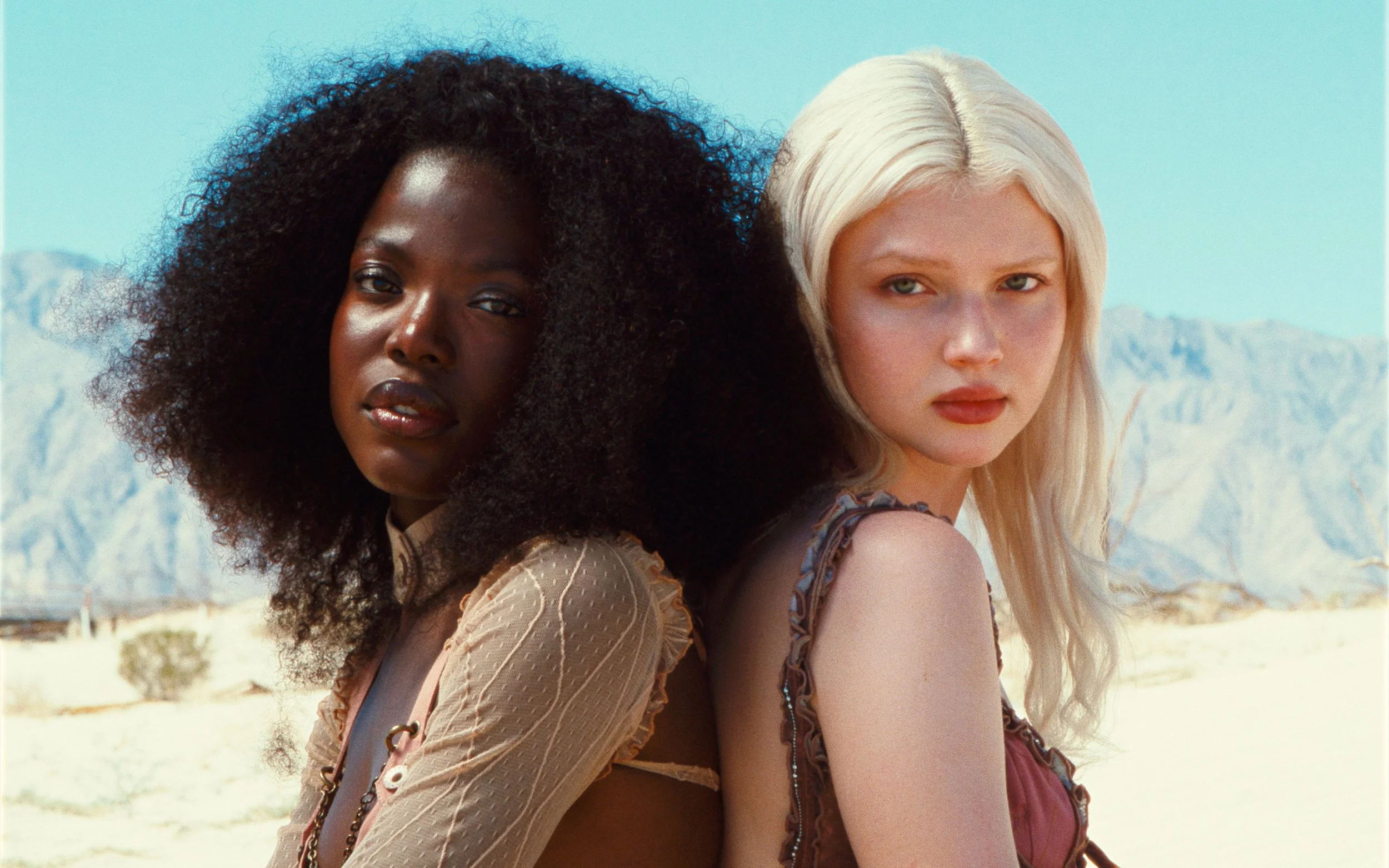 Fashion models in desert scene with vintage kodak film emulation color grade