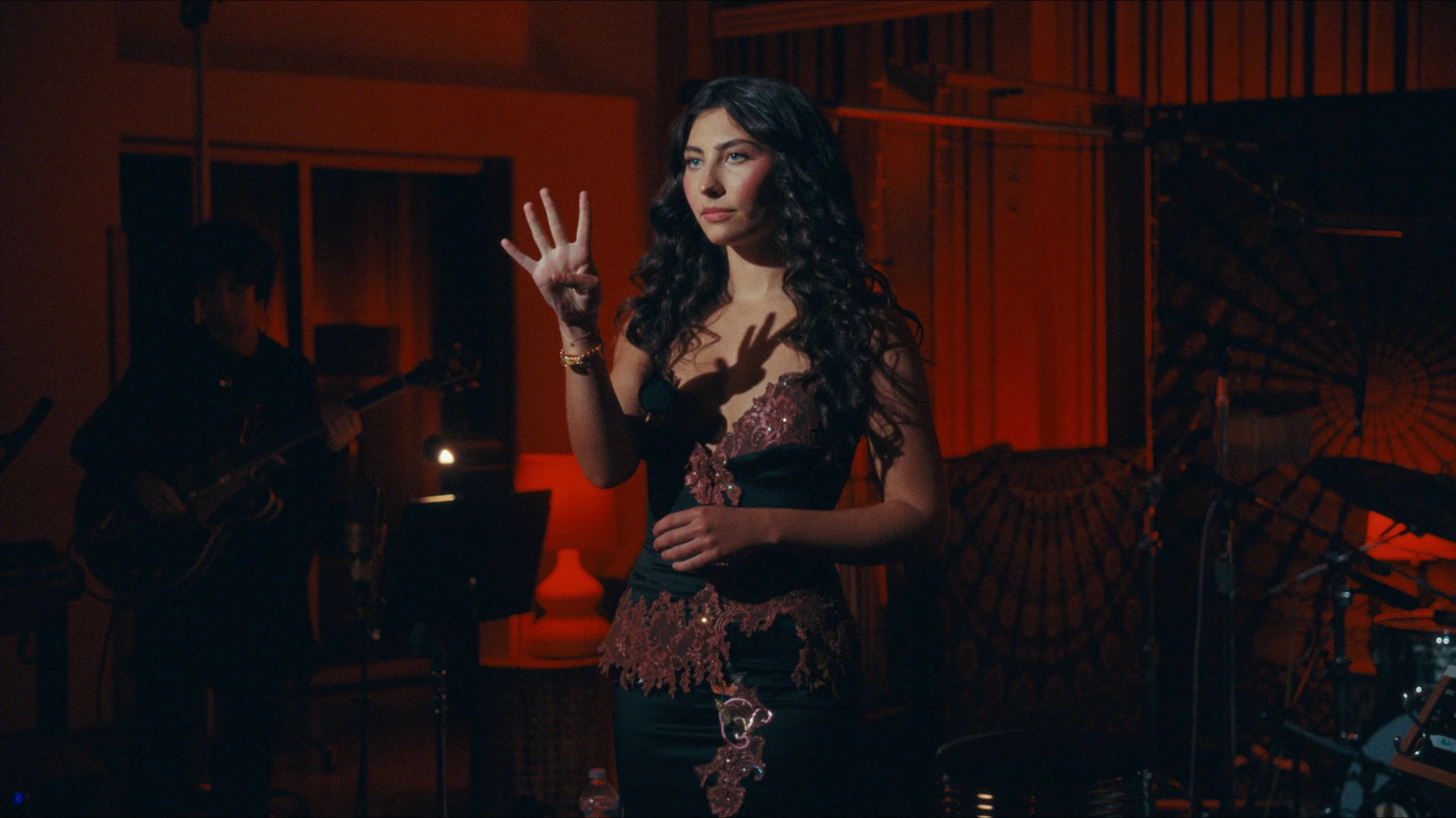 Woman in music recording studio with red light