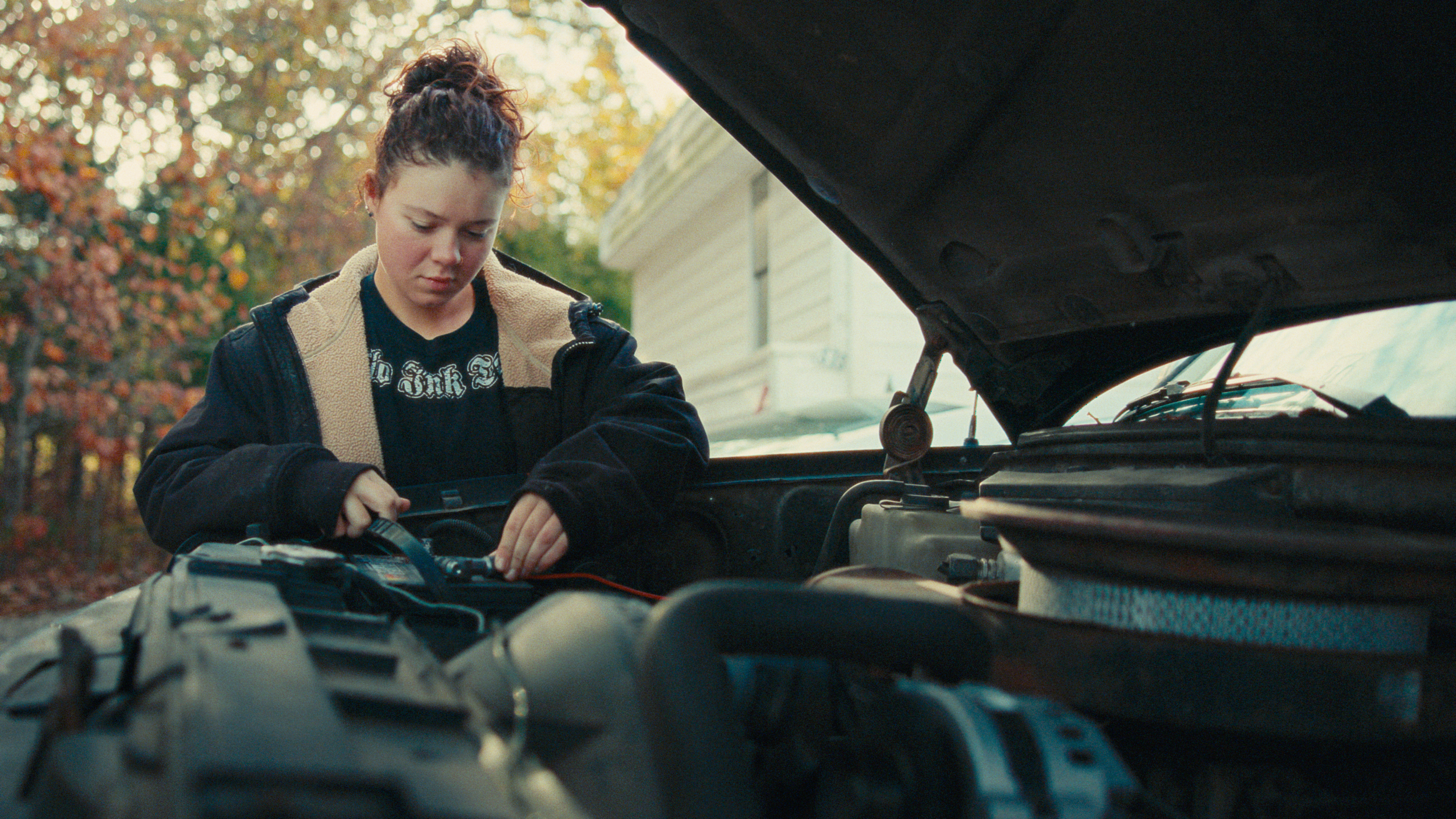 Woman fixing car color graded with Kodak professional 35mm film emulation