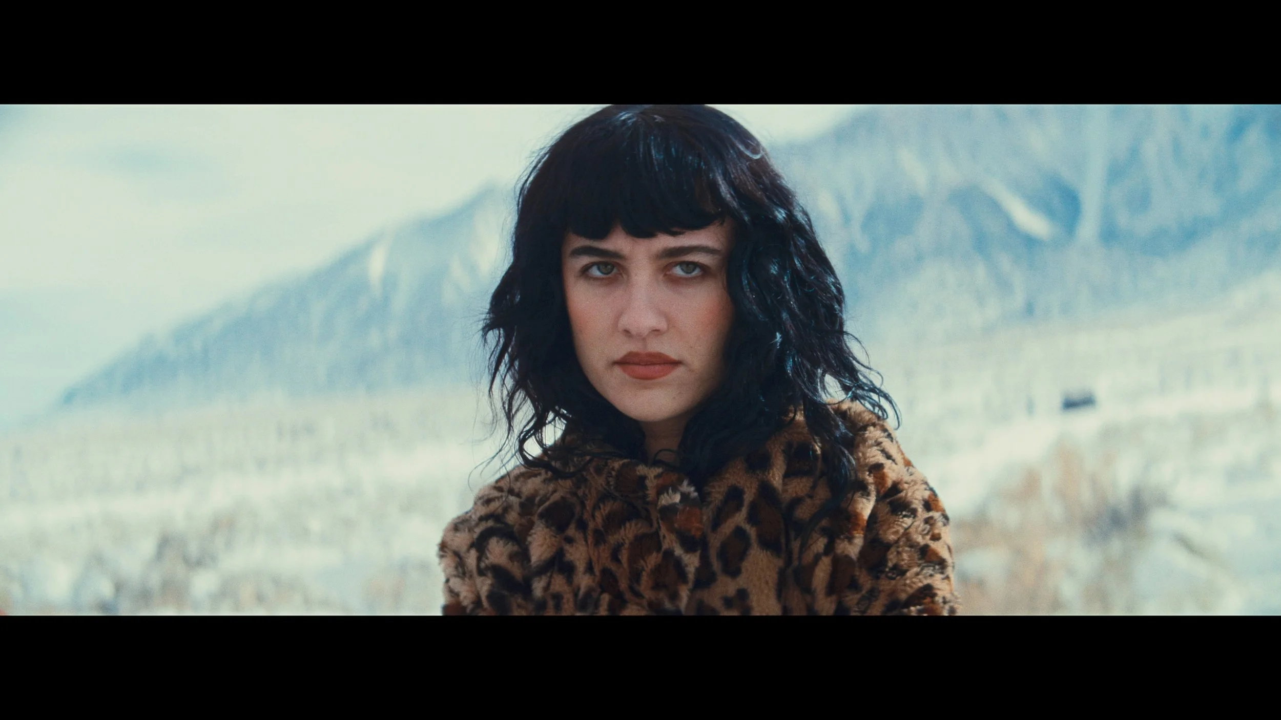 Woman in fur coat in the mountains