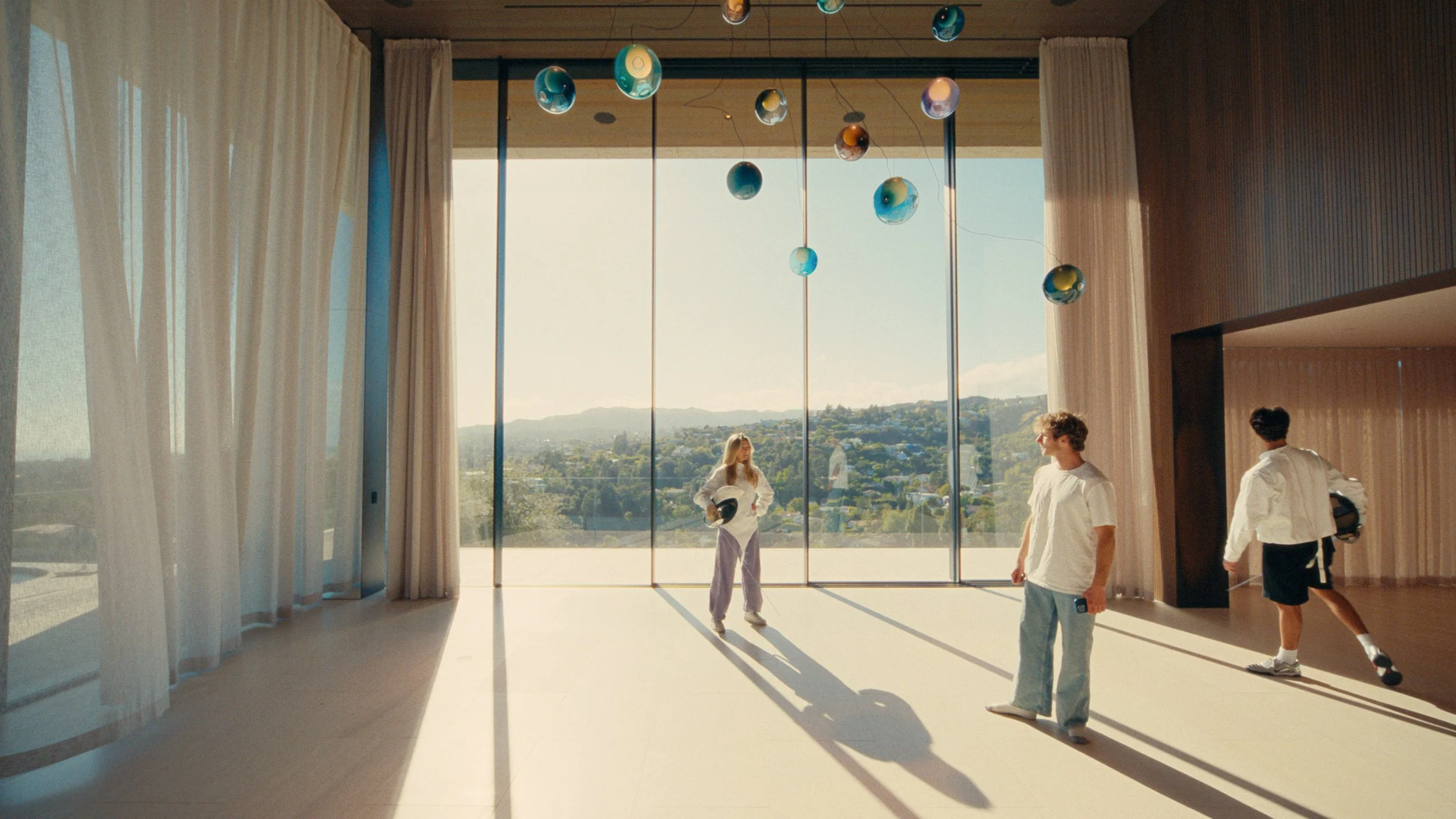 Fencing practice in a room with giant windows