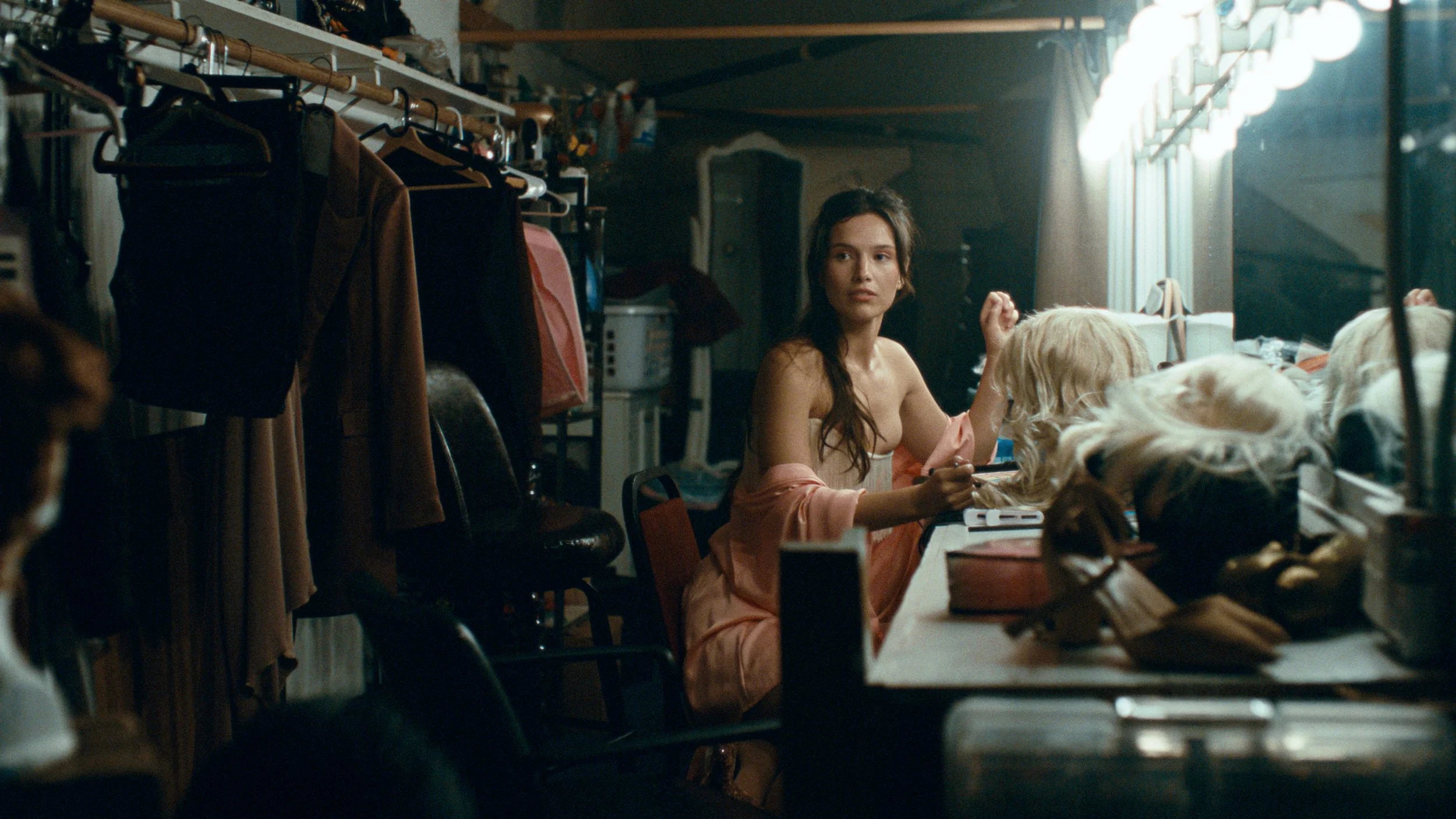 Actress in dressing room with vanity mirror with cold steely cinematic color grade