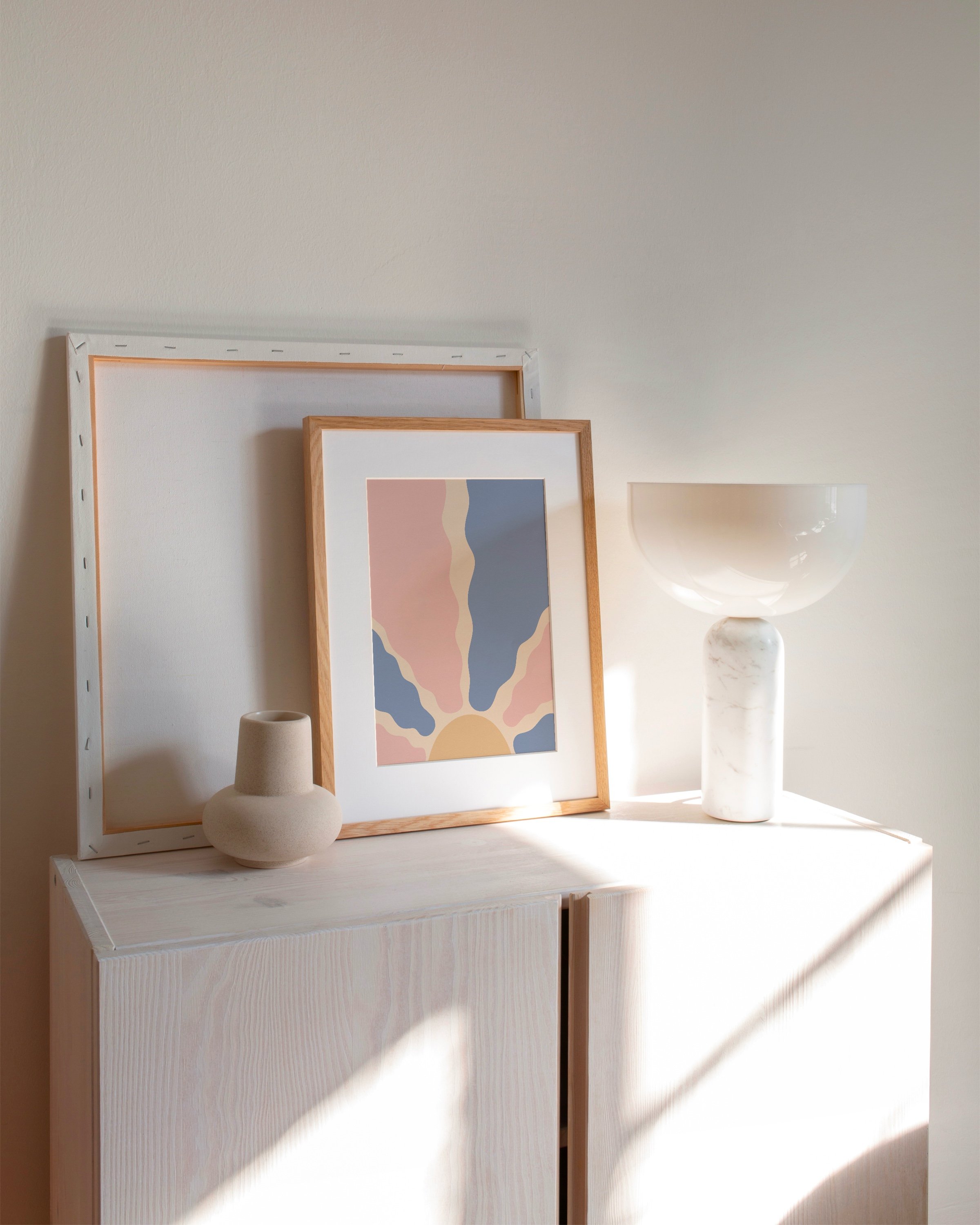 Abstract printable wall art featuring a pastel sunburst design with wavy rays in pink, blue, beige, and yellow.