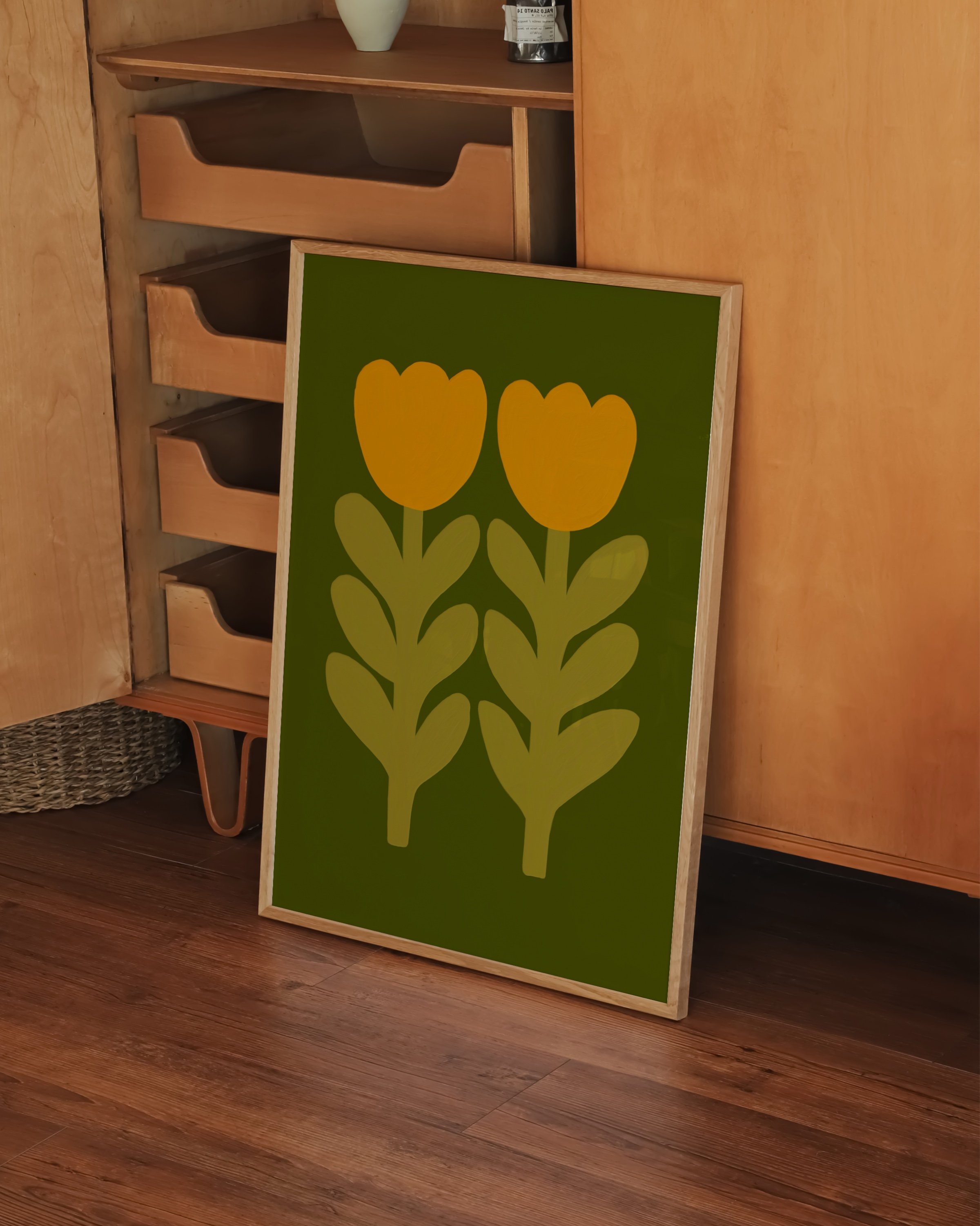Print of two stylized mustard yellow tulips with leafy stems on an olive green background.