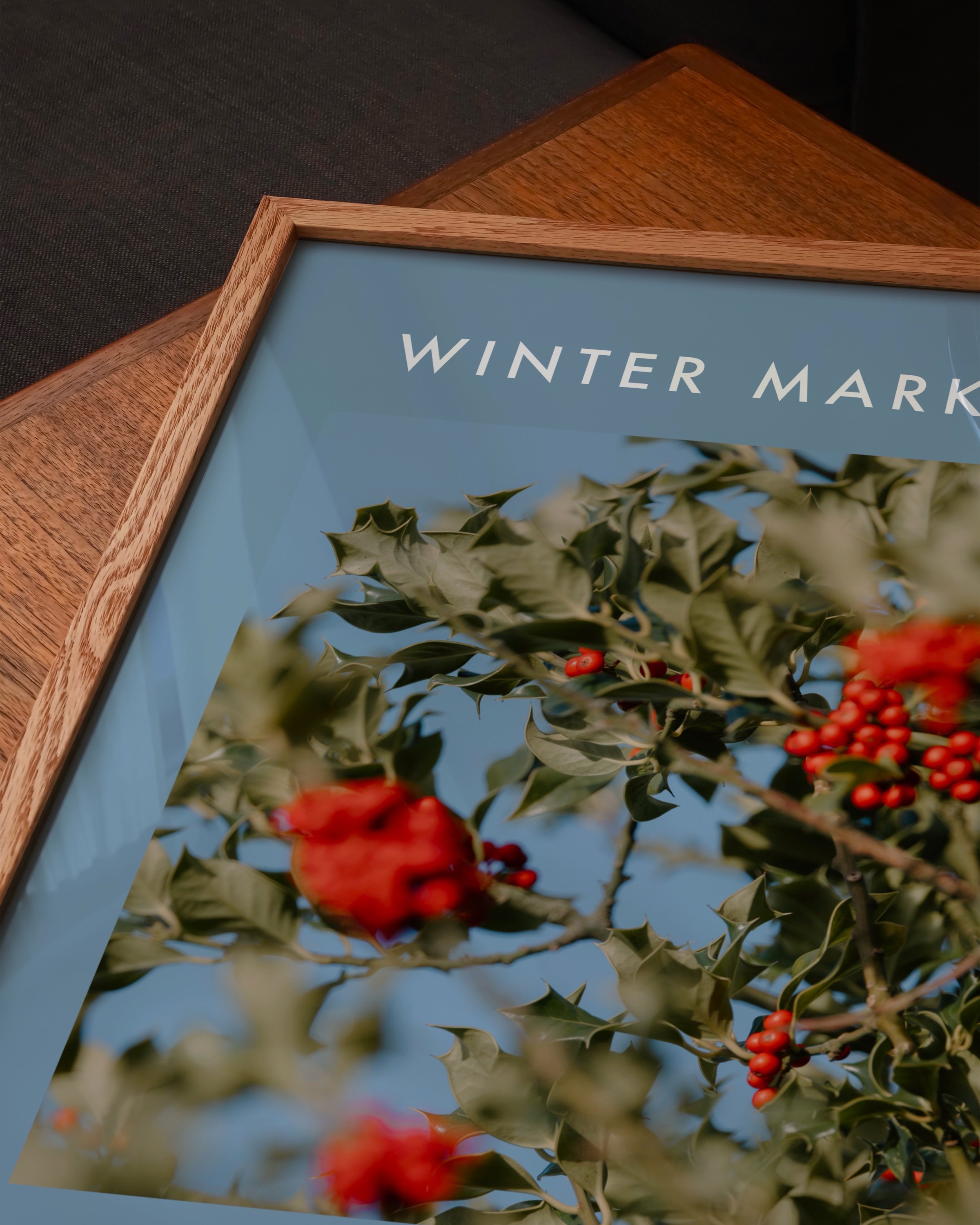 Winter Market seasonal printable wall art featuring a vibrant photo of holly berries with green leaves on a soft blue background.